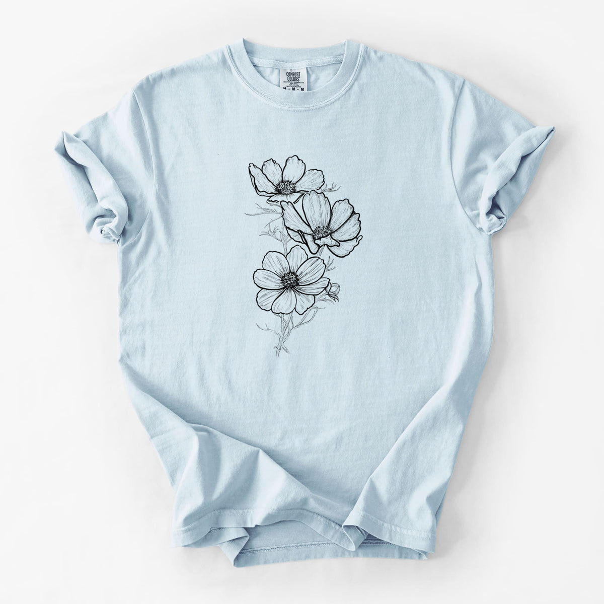 Chambray blue Comfort Colors t-shirt laid flat, printed with a black ink line drawing of garden cosmos flowers on stems.