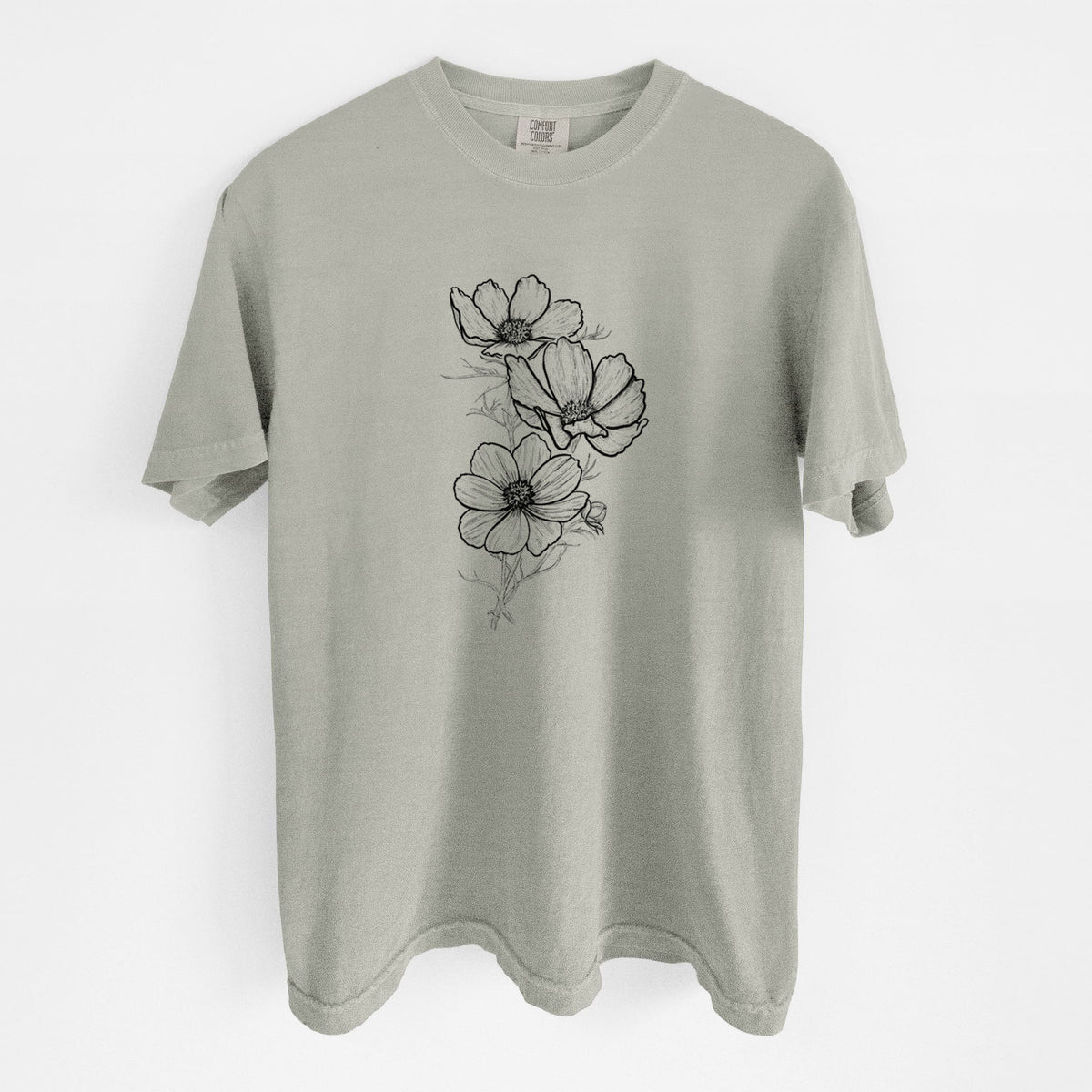 Sandstone beige Comfort Colors t-shirt laid flat, printed with a black ink line drawing of garden cosmos flowers on stems.