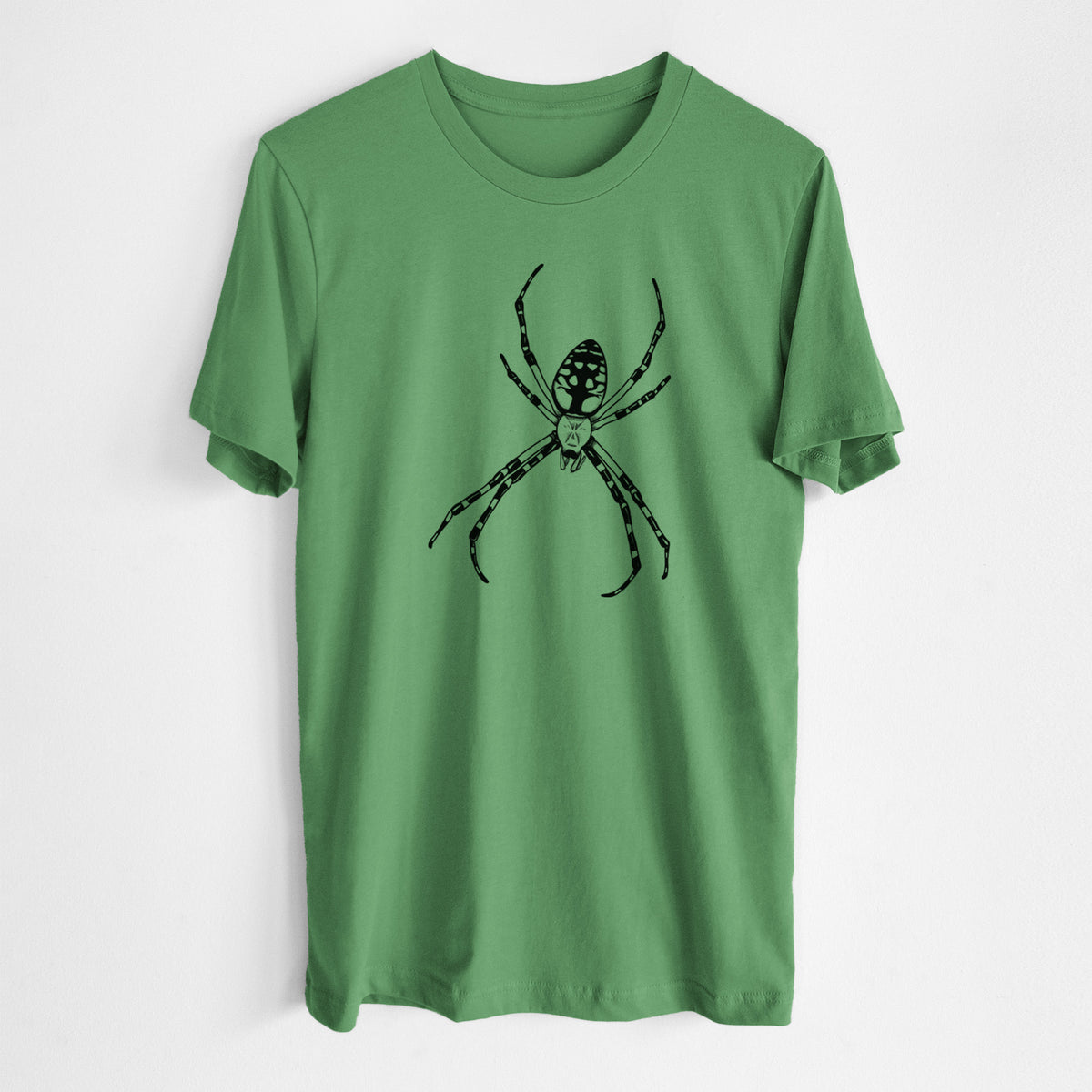 Leaf green lightweight cotton t-shirt laid flat, printed with a detailed black ink illustration of a garden spider with long striped legs.