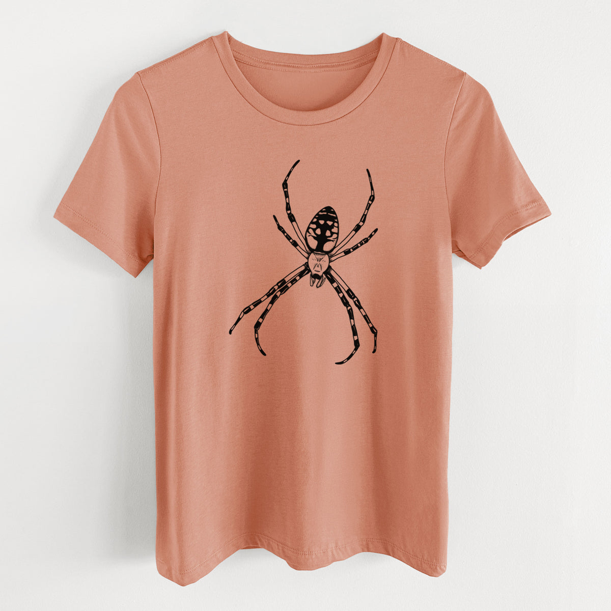 Terracotta orange women's relaxed fit cotton t-shirt laid flat, printed with a detailed black ink illustration of a garden spider with long striped legs.