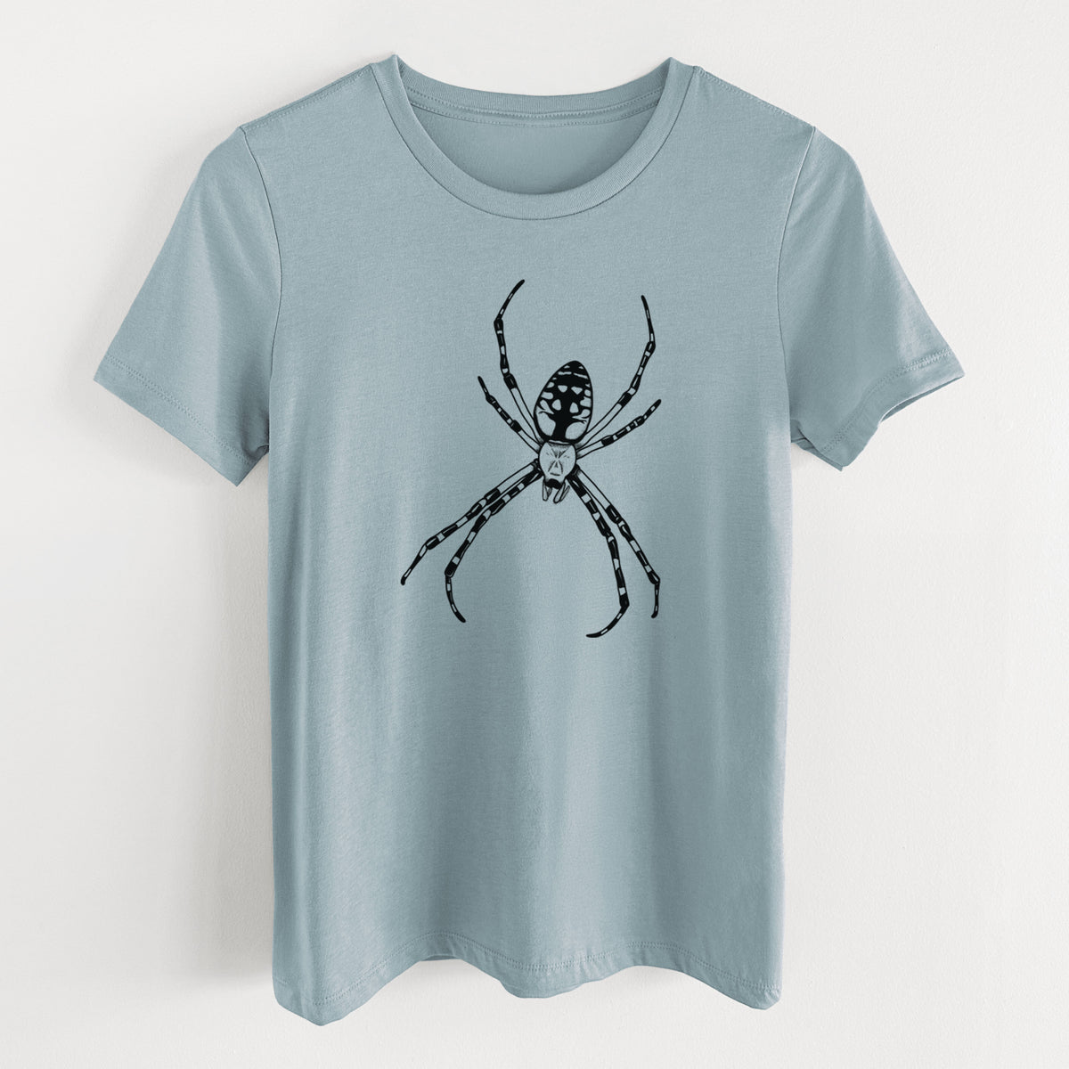 Vintage denim women's relaxed fit cotton t-shirt laid flat, printed with a detailed black ink illustration of a garden spider with long striped legs.