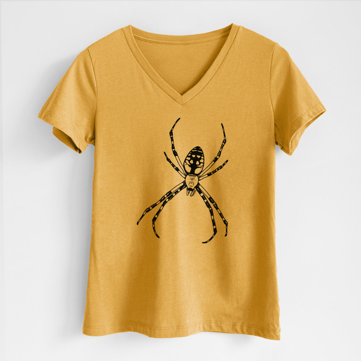 Honeycomb yellow women's relaxed fit cotton V-neck t-shirt laid flat, printed with a detailed black ink illustration of a garden spider with long striped legs.