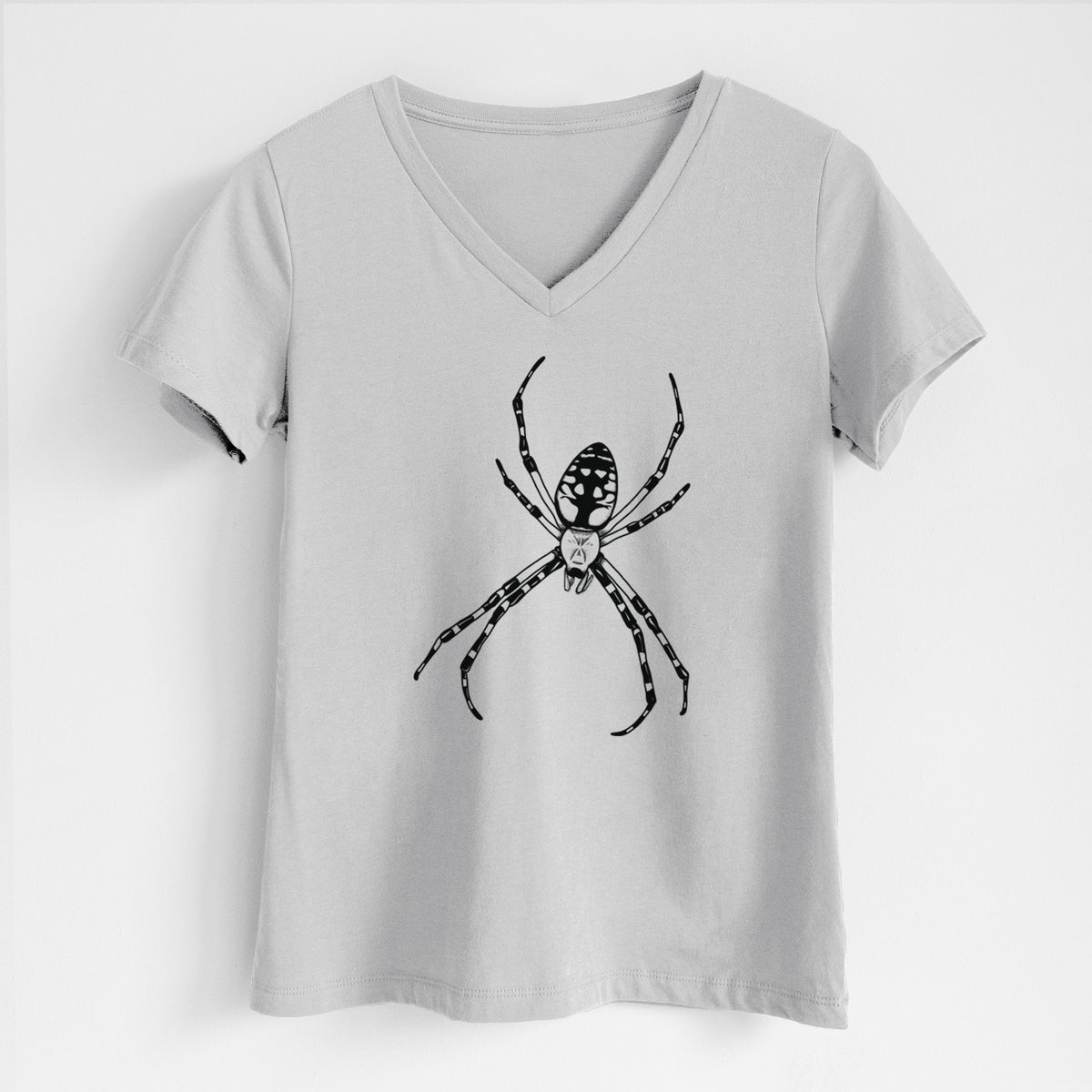 Lunar grey women's relaxed fit cotton V-neck t-shirt laid flat, printed with a detailed black ink illustration of a garden spider with long striped legs.