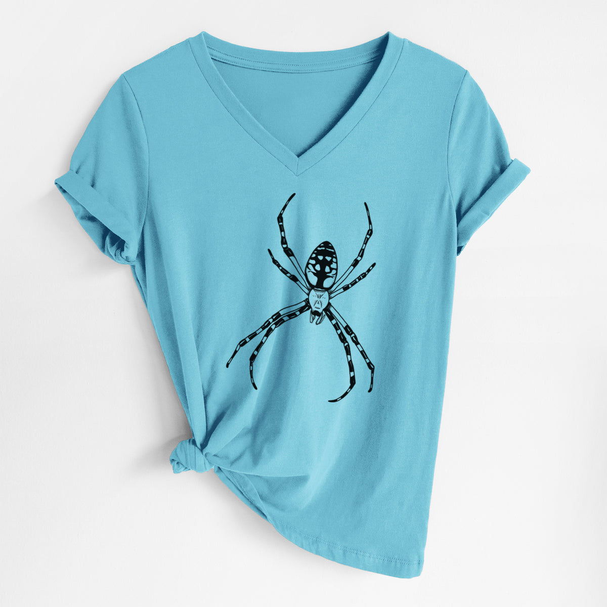 Turquoise women's relaxed fit cotton V-neck t-shirt laid flat, printed with a detailed black ink illustration of a garden spider with long striped legs.
