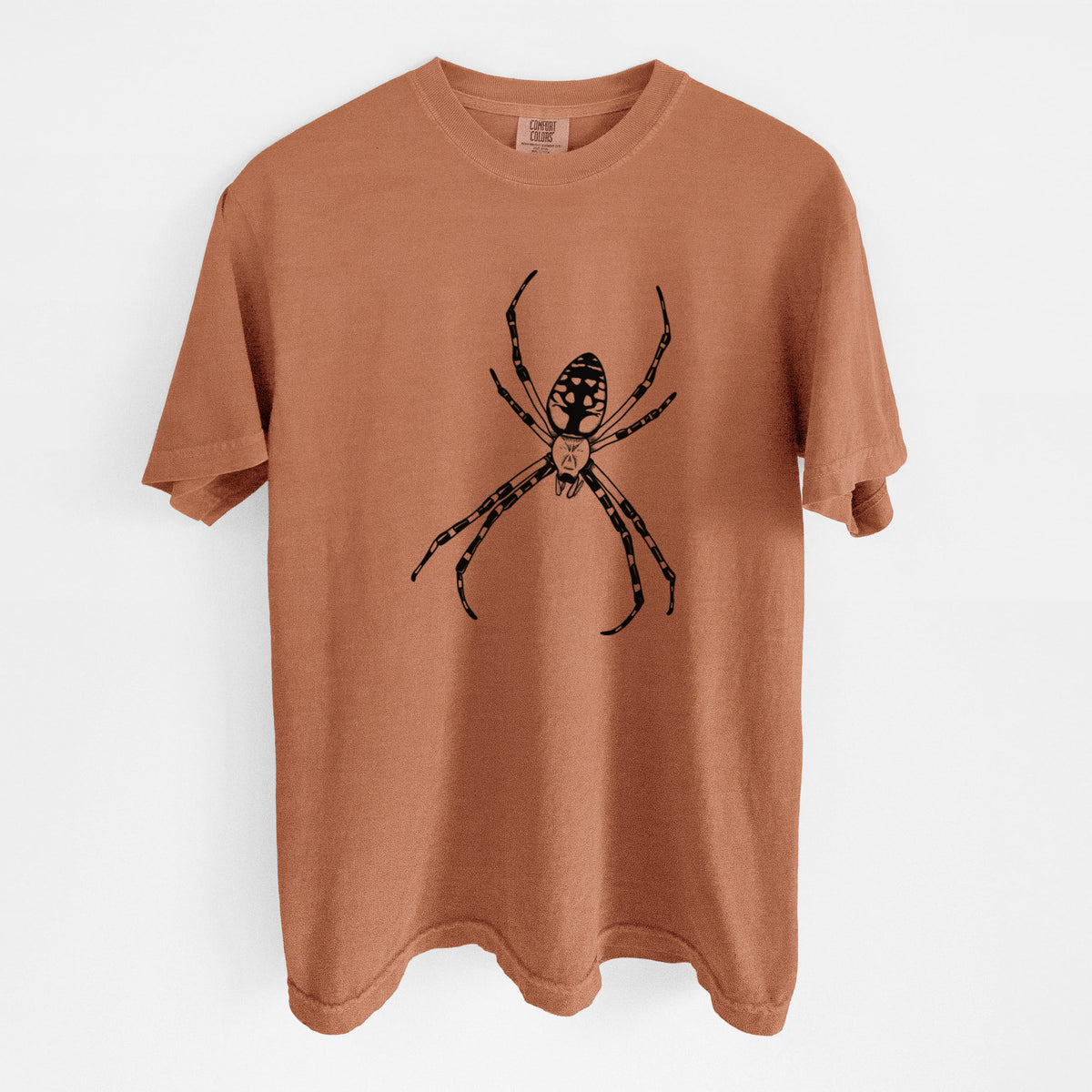 Yam burnt orange Comfort Colors t-shirt laid flat, printed with a detailed black ink illustration of a garden spider with long striped legs.