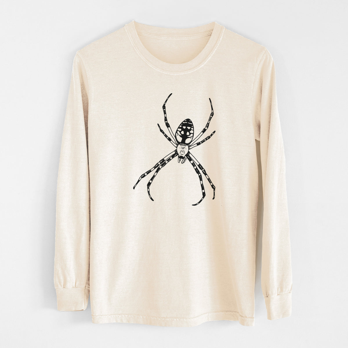 Ivory Comfort Colors long sleeve shirt laid flat, printed with a detailed black ink illustration of a garden spider with long striped legs.