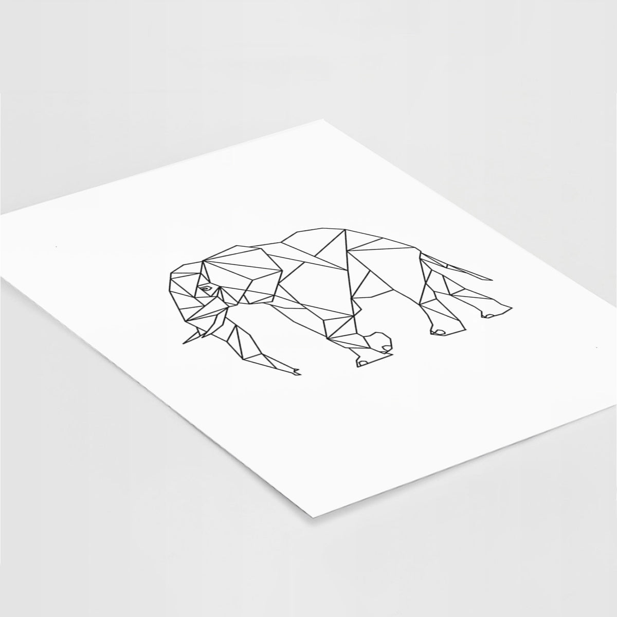Art print of a black geometric line art elephant, lying at an angle on a white surface.