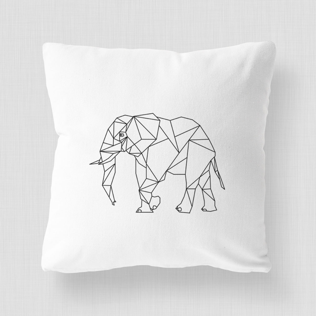 White pillow cover printed with a black geometric line art elephant.