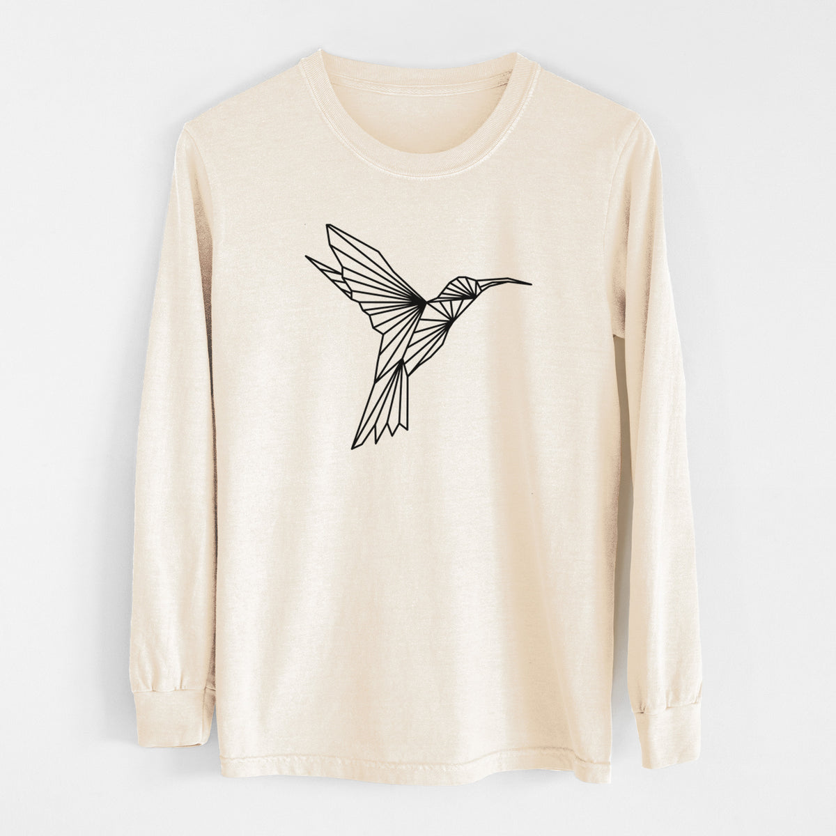 Ivory Comfort Colors long sleeve shirt laid flat, printed with a black geometric line art hummingbird in flight.