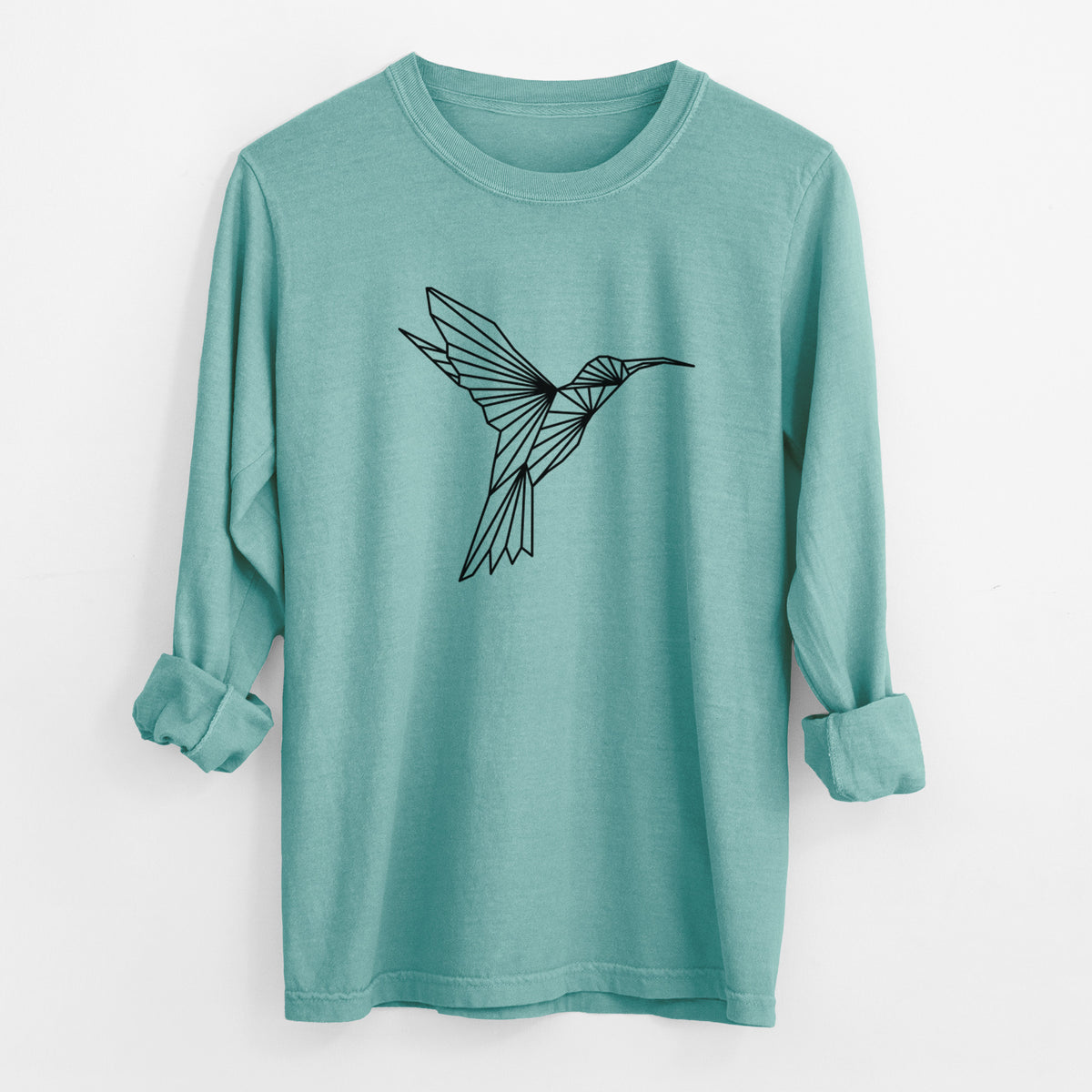 Reef green Comfort Colors long sleeve shirt laid flat with the cuffs rolled, printed with a black geometric line art hummingbird in flight.
