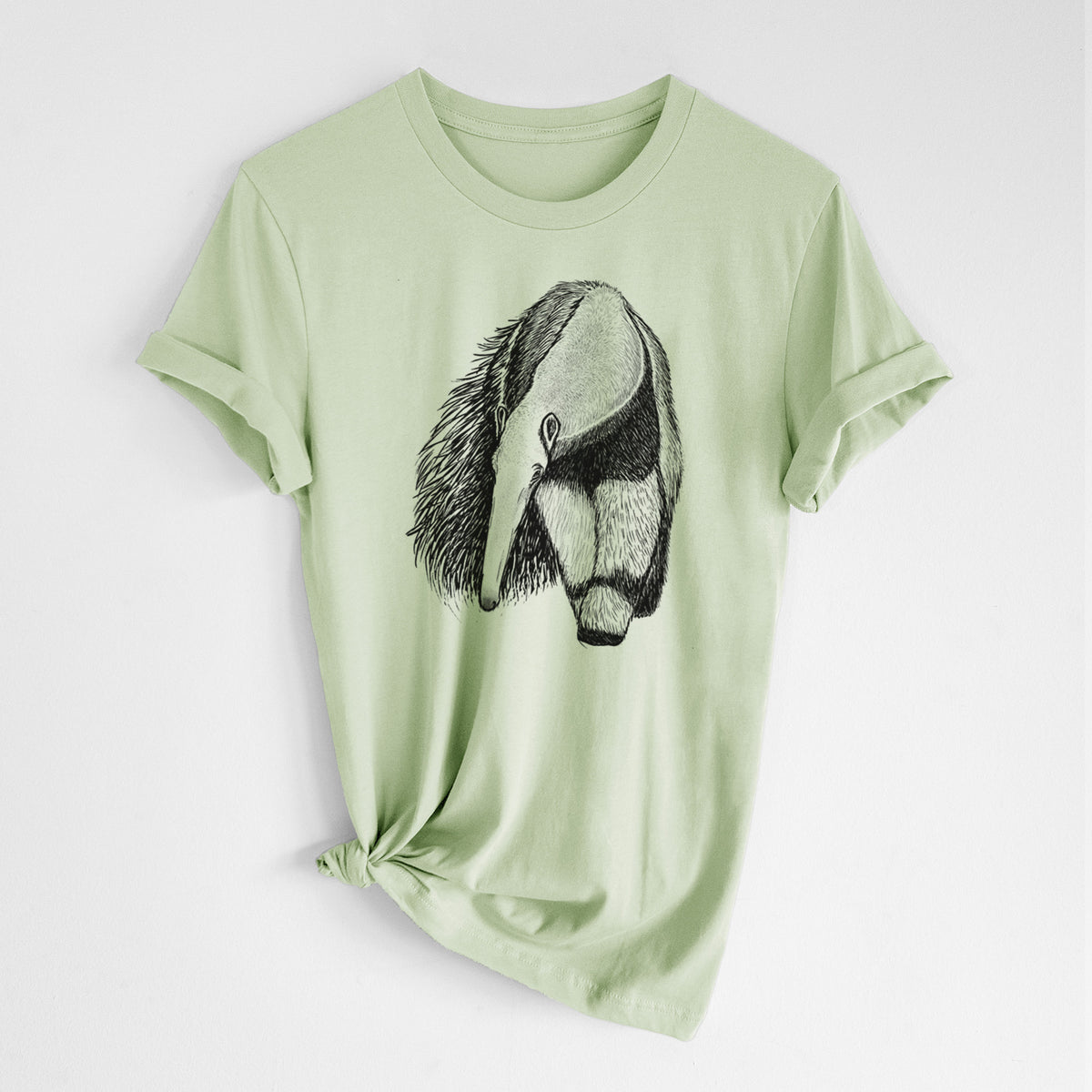 Spring green lightweight cotton t-shirt laid flat with the sleeves rolled, printed with a detailed black ink illustration of a giant anteater with its long snout and bushy tail.