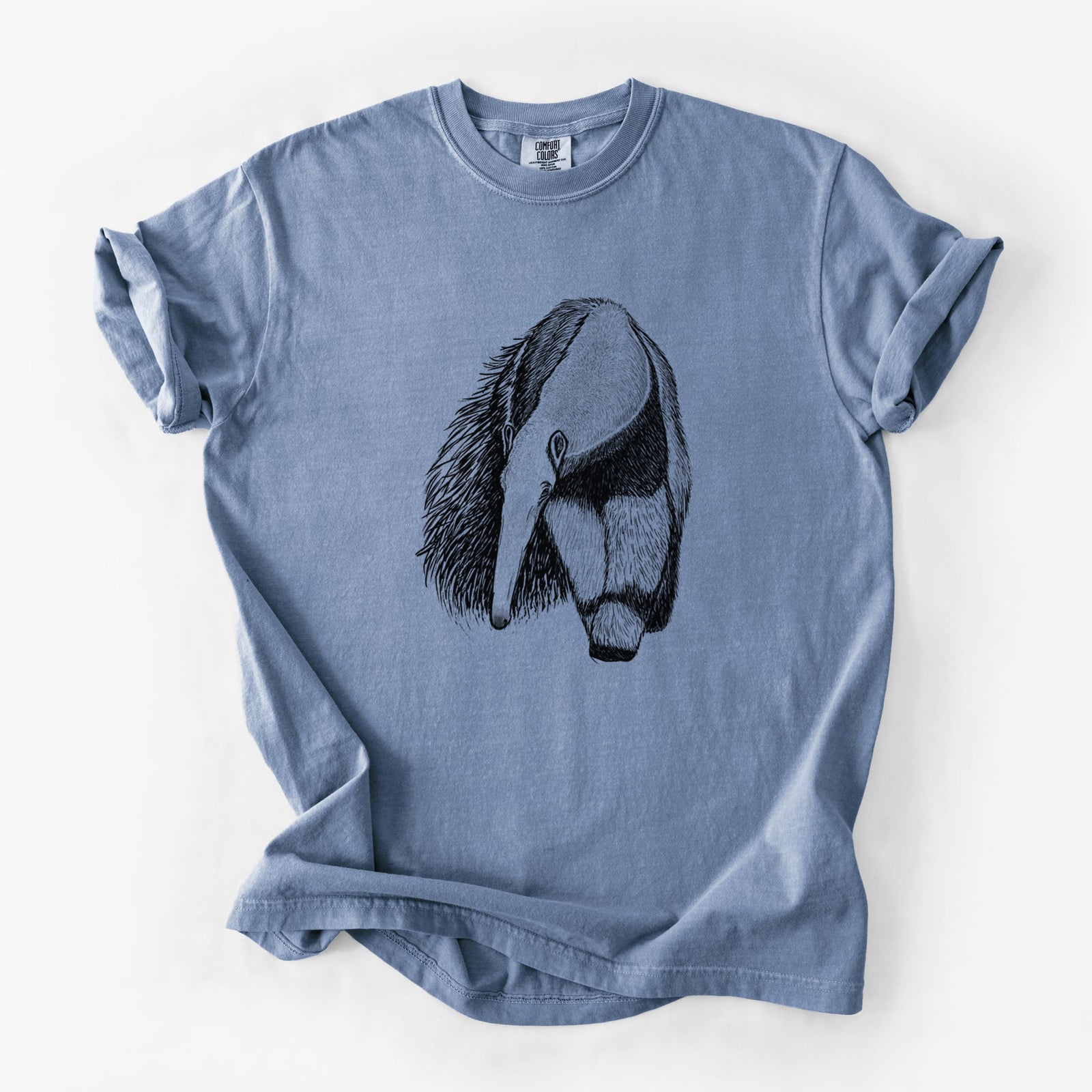 Blue jean Comfort Colors t-shirt laid flat, printed with a detailed black ink illustration of a giant anteater with its long snout and bushy tail.