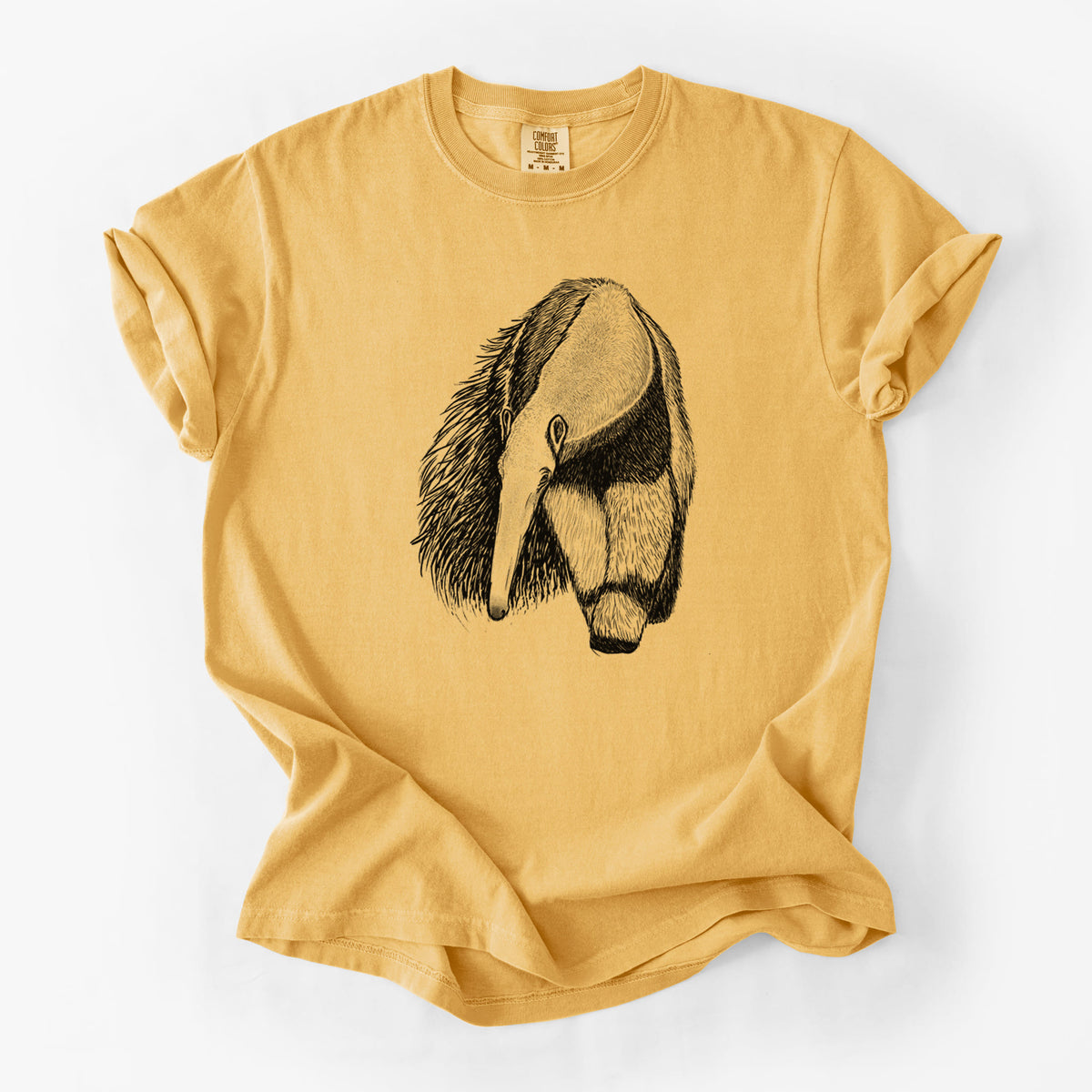 Golden wheat yellow Comfort Colors t-shirt laid flat, printed with a detailed black ink illustration of a giant anteater with its long snout and bushy tail.