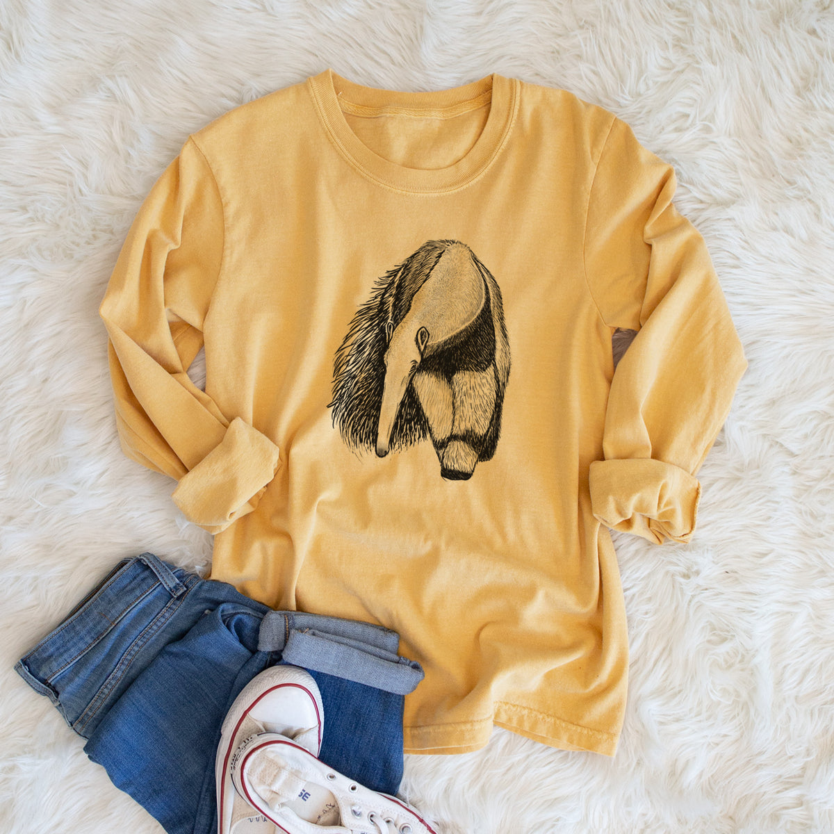 Golden wheat yellow Comfort Colors long sleeve shirt printed with a detailed black ink illustration of a giant anteater with its long snout and bushy tail, shown in a lifestyle photo.