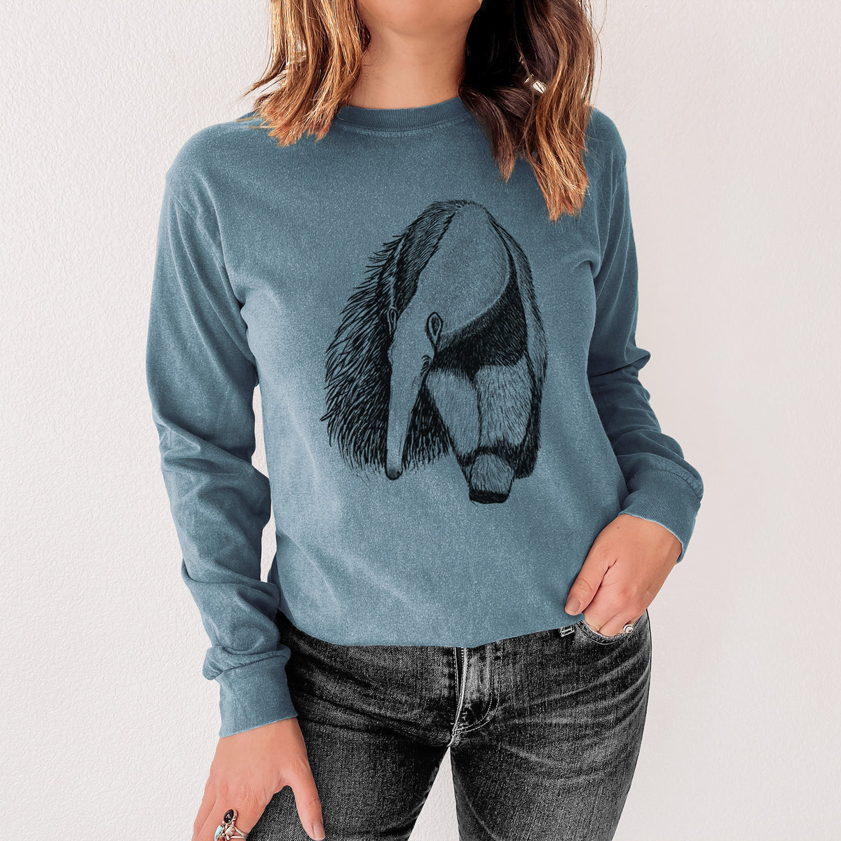 Steel blue Comfort Colors long sleeve shirt printed with a detailed black ink illustration of a giant anteater with its long snout and bushy tail, shown in a lifestyle photo.