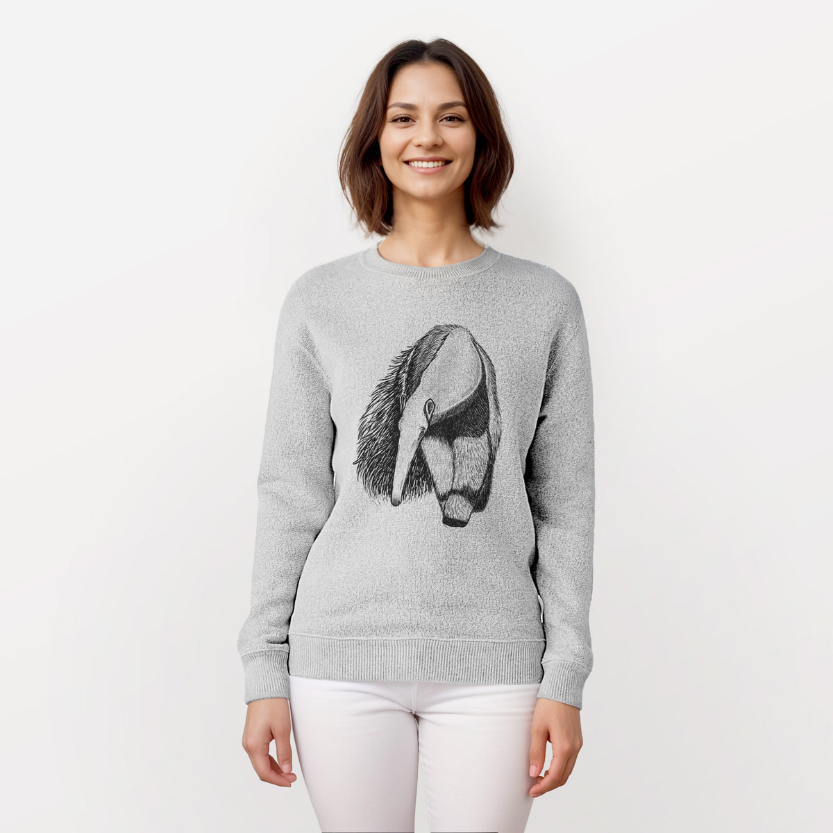 Woman wearing a knit sweatshirt printed with a detailed black ink illustration of a giant anteater with its long snout and bushy tail.
