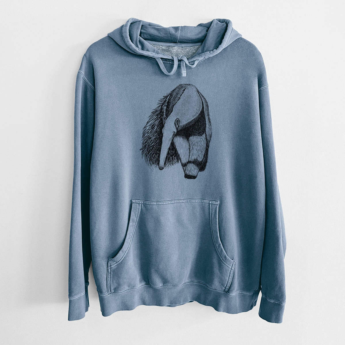 Slate blue pigment dyed hoodie laid flat, printed with a detailed black ink illustration of a giant anteater with its long snout and bushy tail.