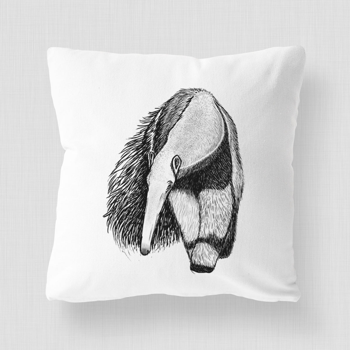 White pillow cover printed with a detailed black ink illustration of a giant anteater with its long snout and bushy tail.