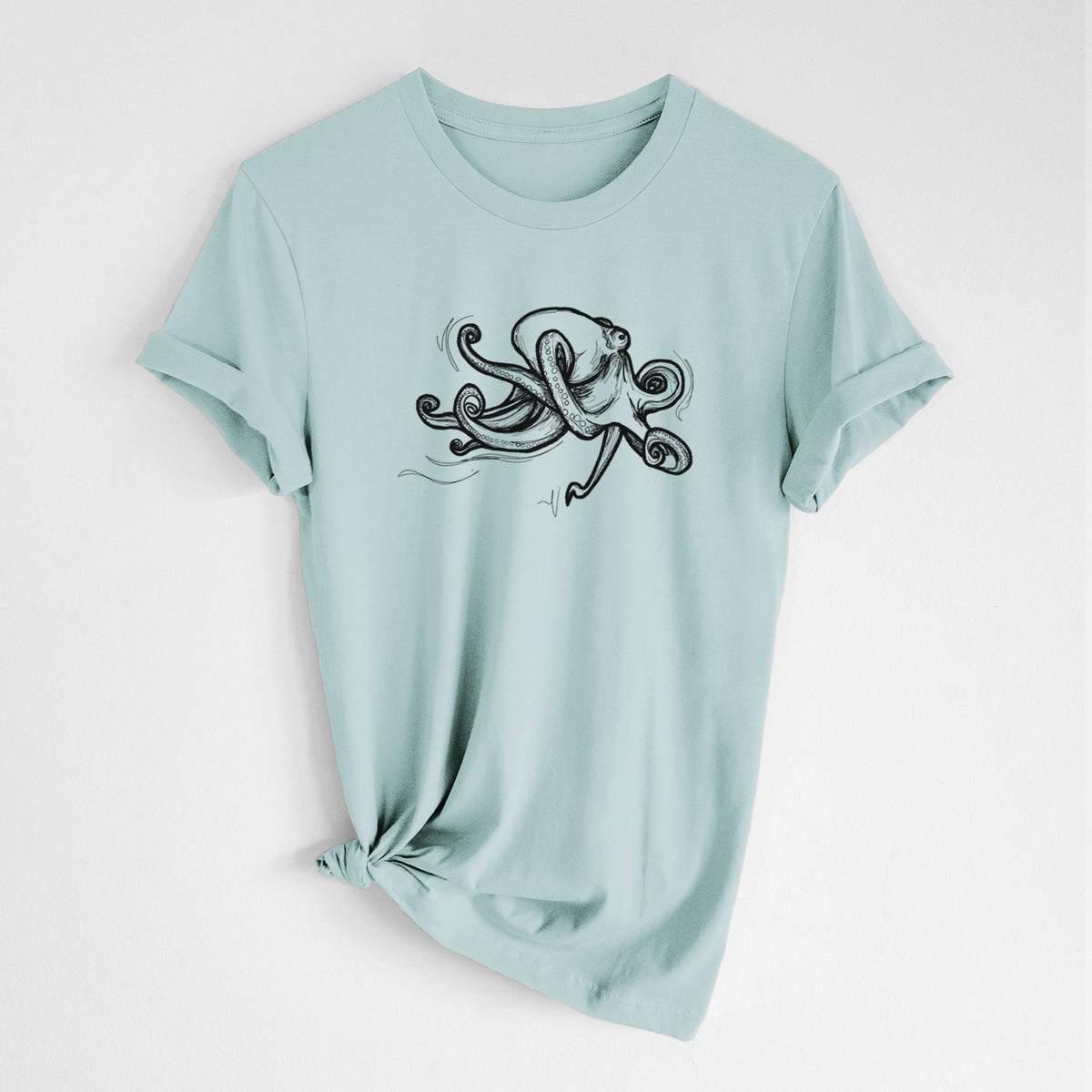 Dusty blue lightweight cotton t-shirt laid flat with the sleeves rolled, printed with a black ink illustration of a giant Pacific octopus with curling tentacles.