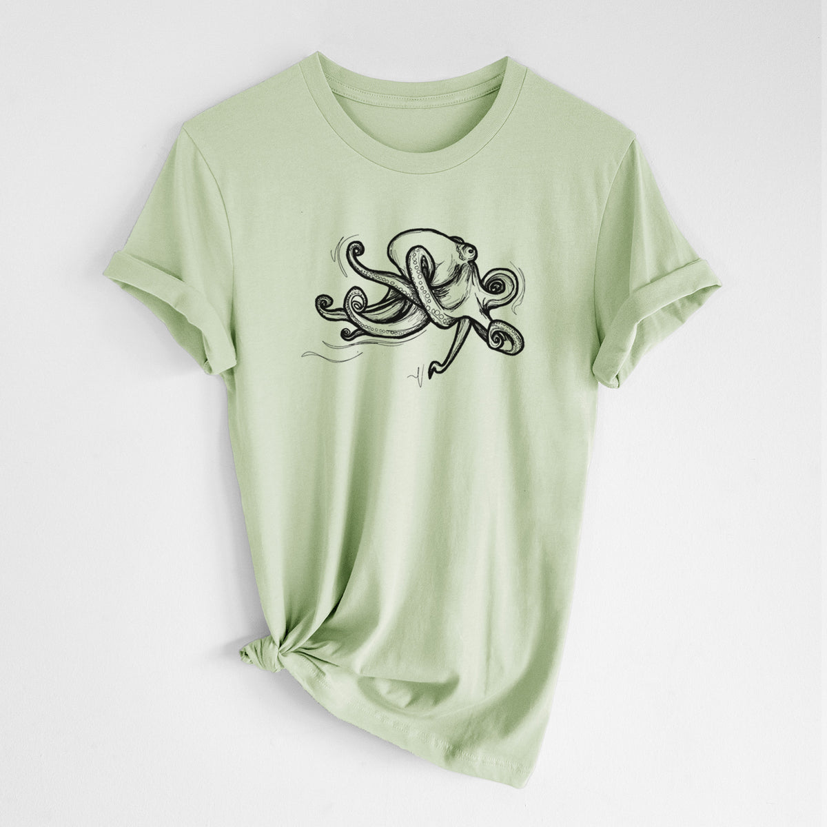 Spring green lightweight cotton t-shirt laid flat with the sleeves rolled, printed with a black ink illustration of a giant Pacific octopus with curling tentacles.