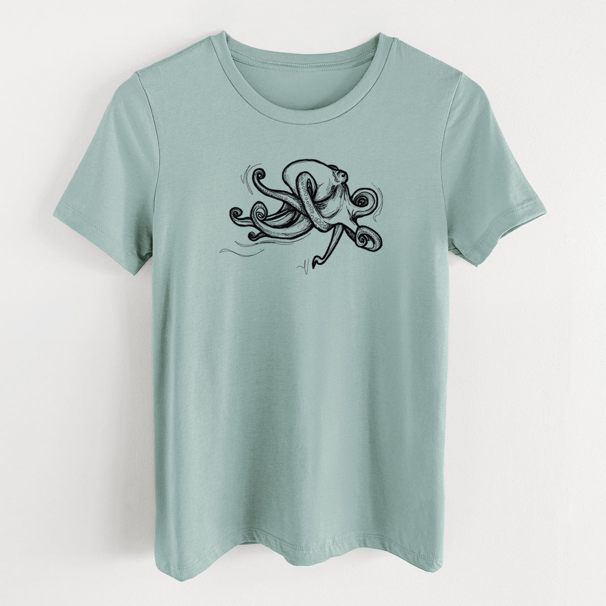 Dusty blue women's relaxed fit cotton t-shirt laid flat, printed with a black ink illustration of a giant Pacific octopus with curling tentacles.