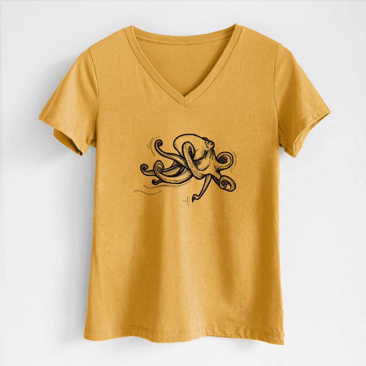 Honeycomb yellow women's relaxed fit cotton V-neck t-shirt laid flat, printed with a black ink illustration of a giant Pacific octopus with curling tentacles.