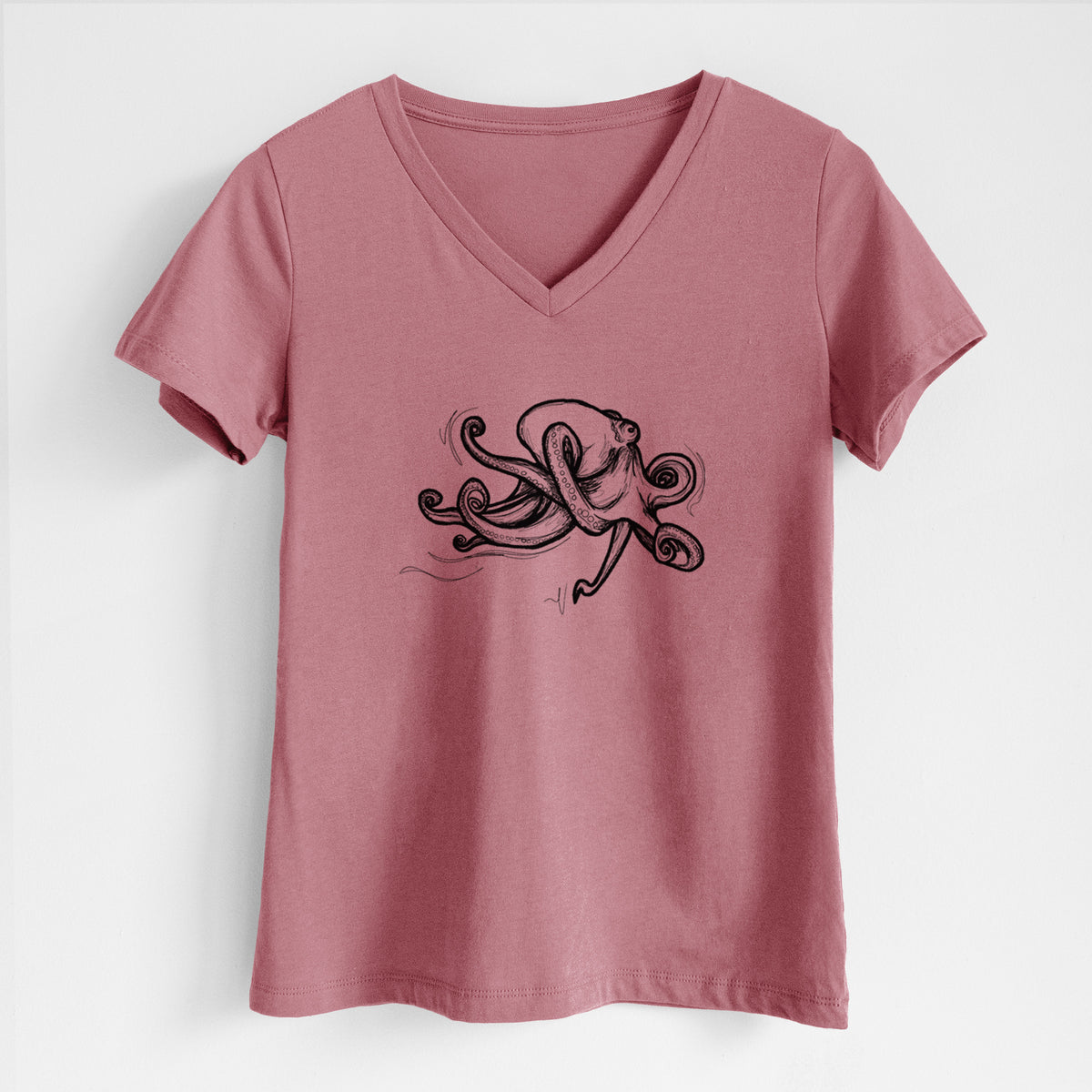 Mauve pink women's relaxed fit cotton V-neck t-shirt laid flat, printed with a black ink illustration of a giant Pacific octopus with curling tentacles.