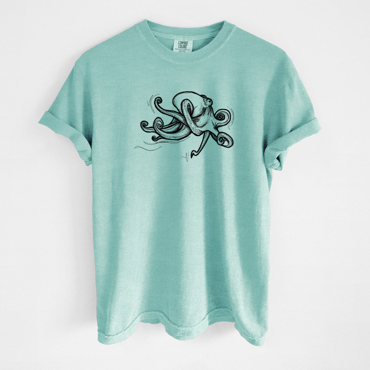 Chalky mint Comfort Colors t-shirt laid flat, printed with a black ink illustration of a giant Pacific octopus with curling tentacles.