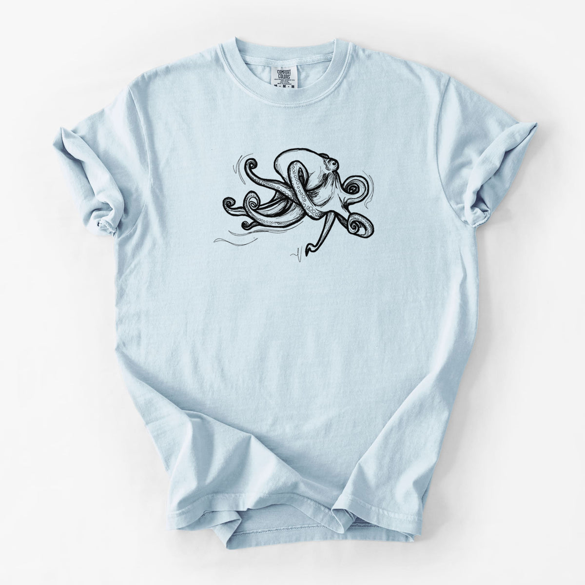 Chambray blue Comfort Colors t-shirt laid flat, printed with a black ink illustration of a giant Pacific octopus with curling tentacles.