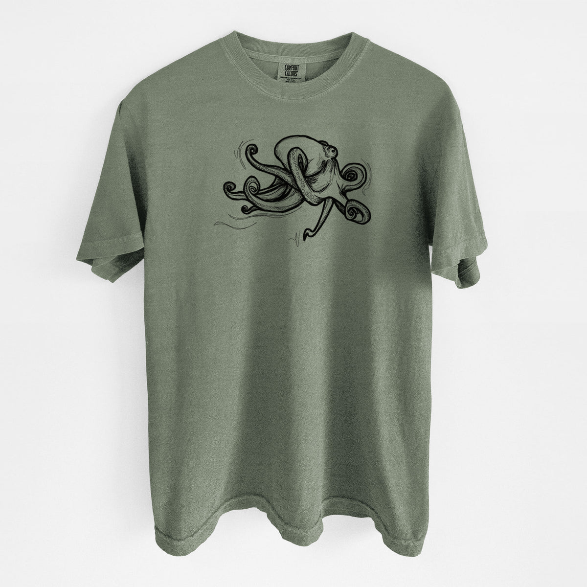 Moss green Comfort Colors t-shirt laid flat, printed with a black ink illustration of a giant Pacific octopus with curling tentacles.