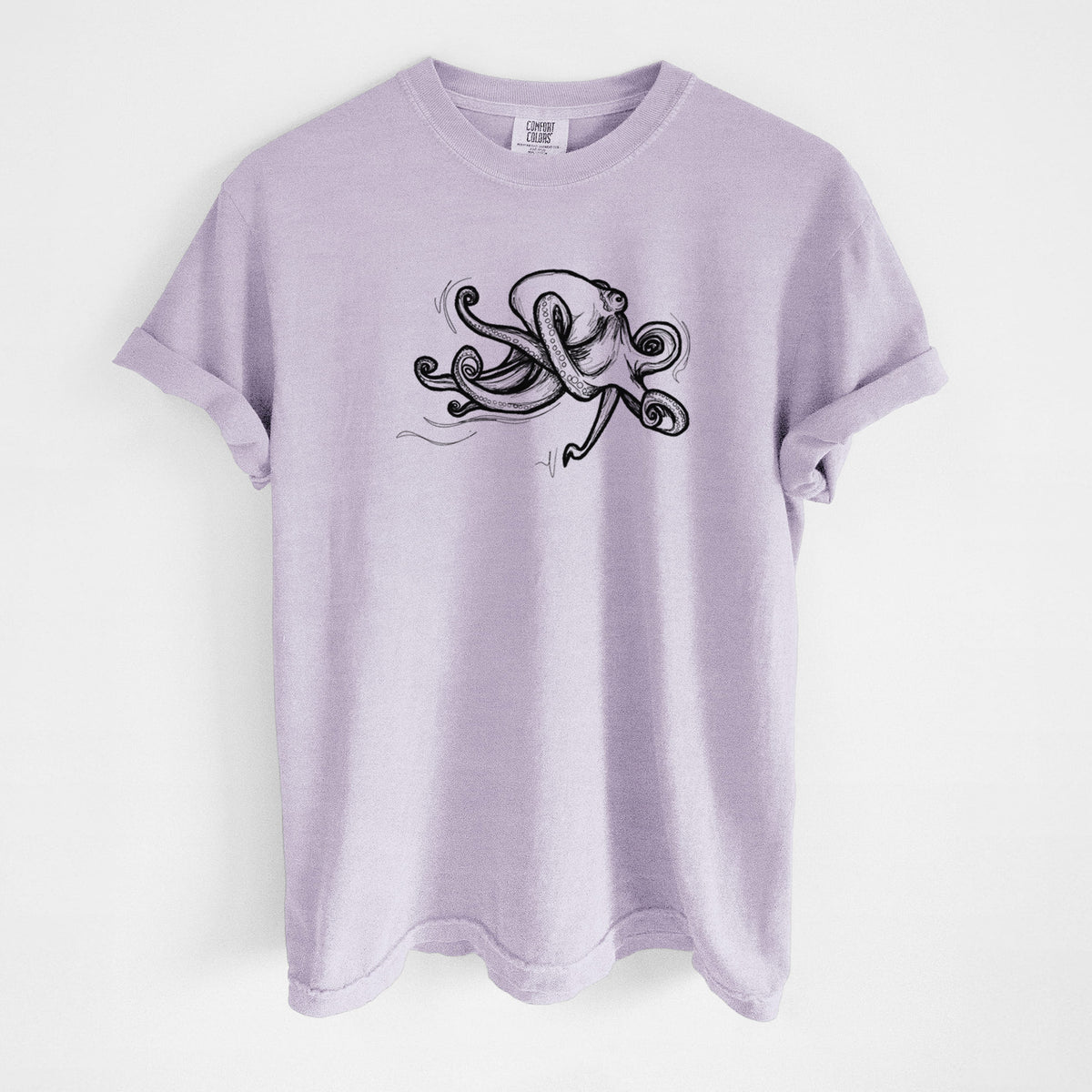 Orchid purple Comfort Colors t-shirt laid flat, printed with a black ink illustration of a giant Pacific octopus with curling tentacles.