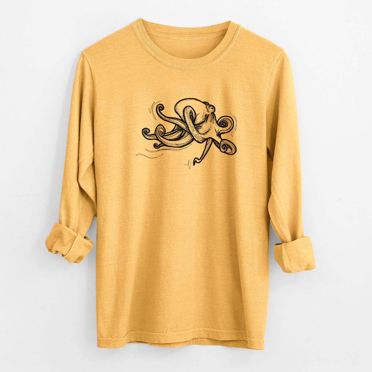 Golden wheat yellow Comfort Colors long sleeve shirt laid flat with the cuffs rolled, printed with a black ink illustration of a giant Pacific octopus with curling tentacles.