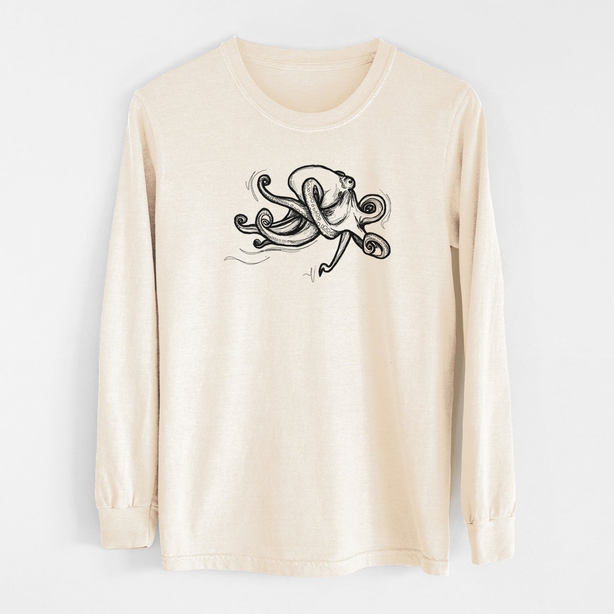 Ivory Comfort Colors long sleeve shirt laid flat, printed with a black ink illustration of a giant Pacific octopus with curling tentacles.