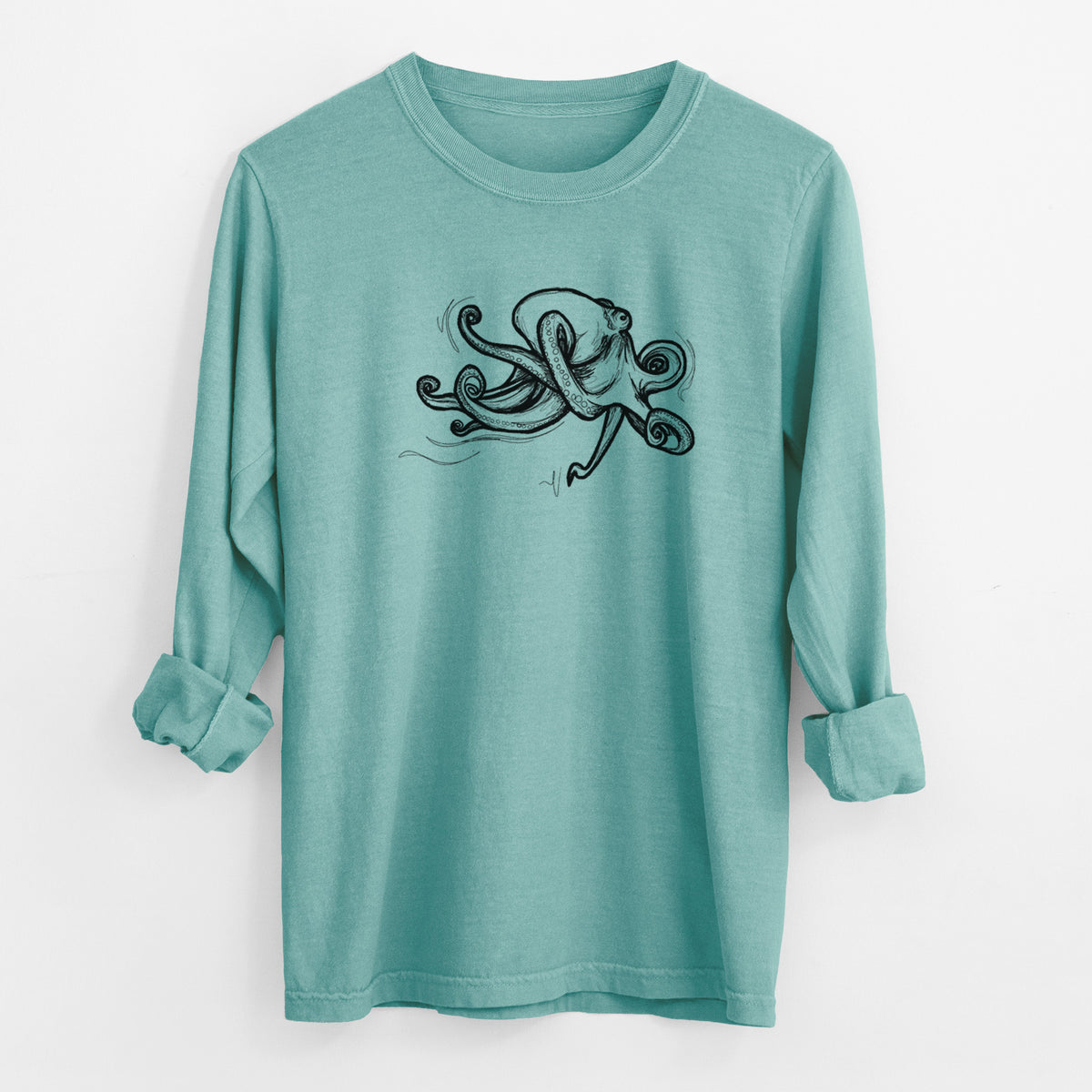 Reef green Comfort Colors long sleeve shirt laid flat with the cuffs rolled, printed with a black ink illustration of a giant Pacific octopus with curling tentacles.