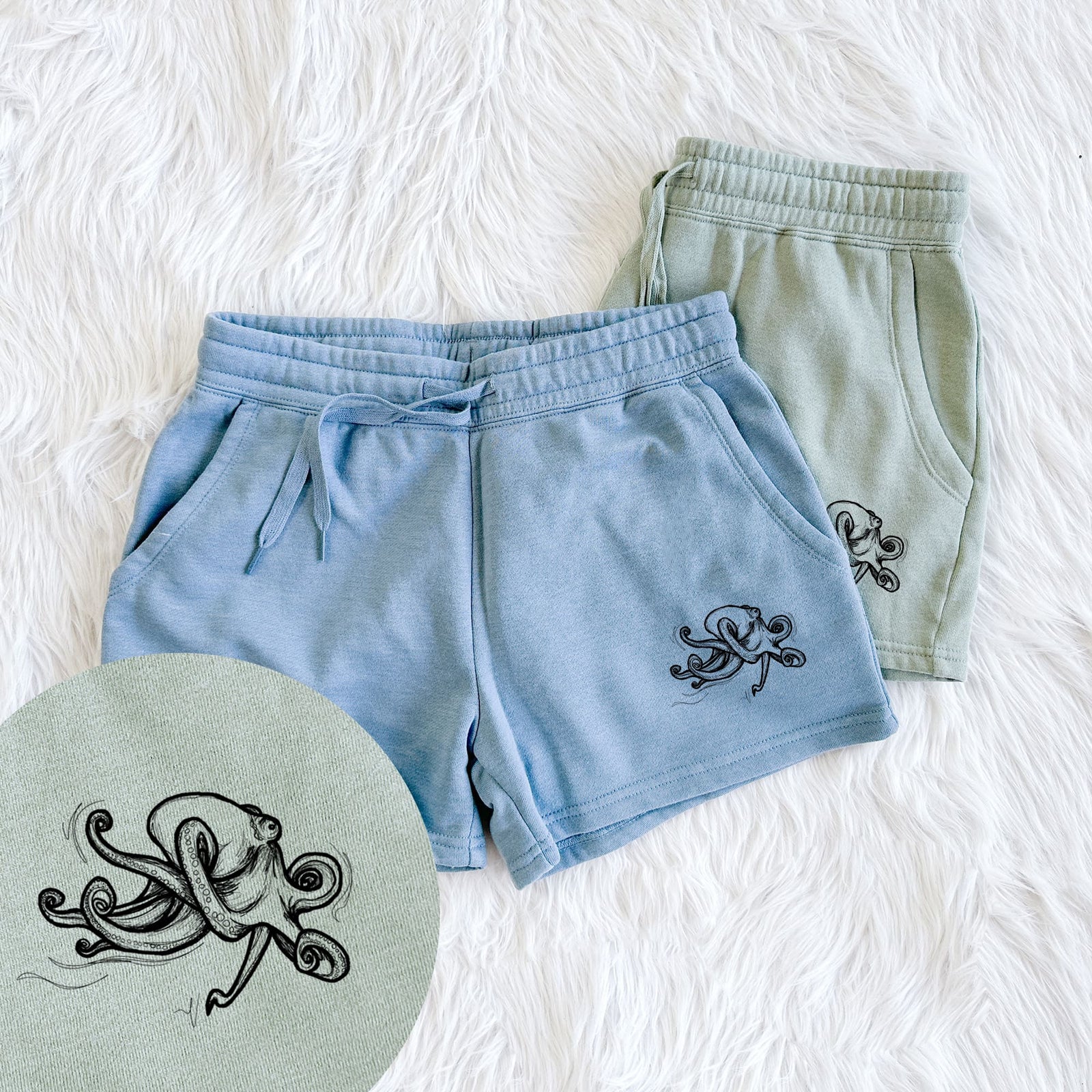 Two pairs of Cali Wave shorts in different colors printed with a black ink illustration of a giant Pacific octopus with curling tentacles, with a close-up of the print.