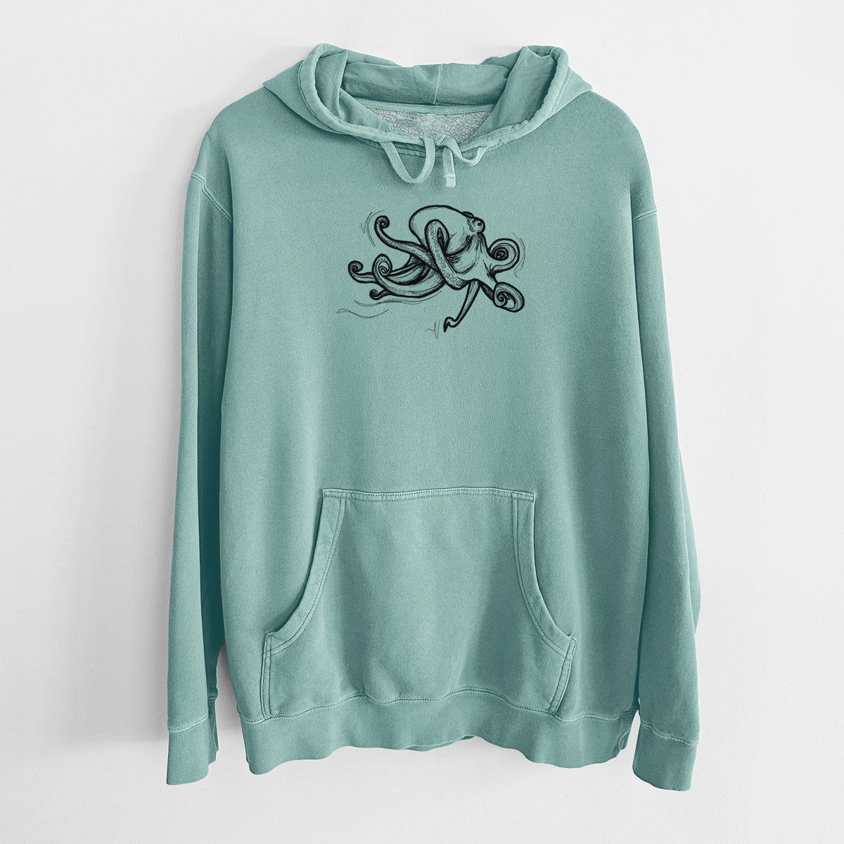 Mint green pigment dyed hoodie laid flat, printed with a black ink illustration of a giant Pacific octopus with curling tentacles.