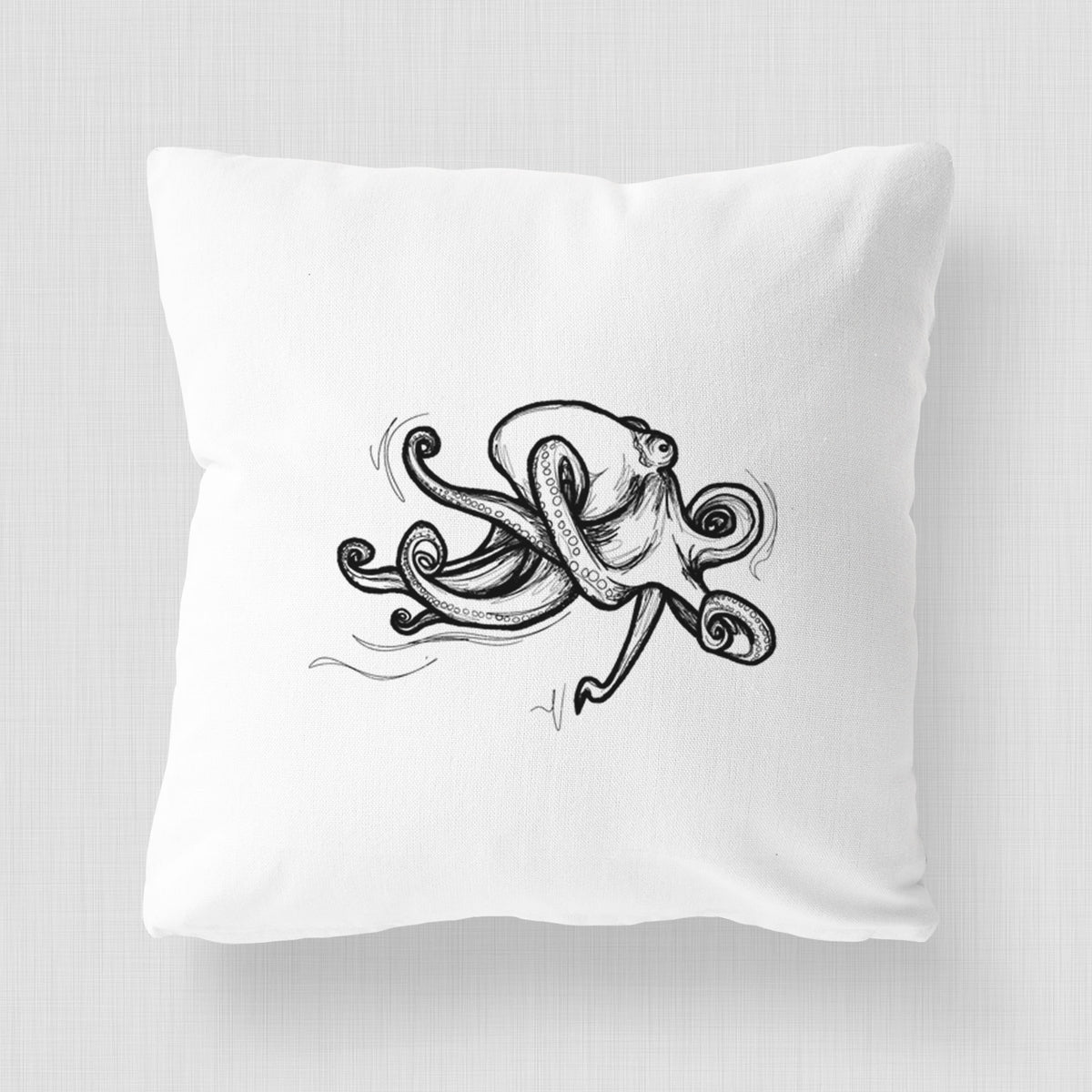 White pillow cover printed with a black ink illustration of a giant Pacific octopus with curling tentacles.