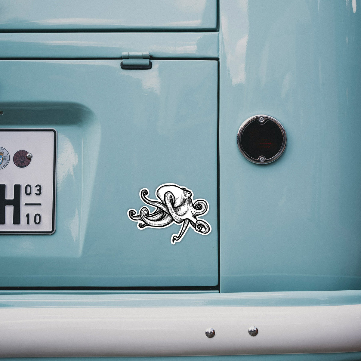 4 inch vinyl decal of a black ink illustration of a giant Pacific octopus with curling tentacles on the back of a van.