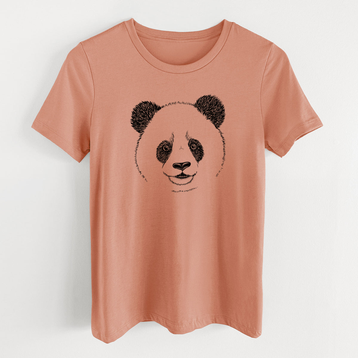 Terracotta orange women's relaxed fit cotton t-shirt laid flat, printed with a black ink portrait of a smiling giant panda's face.