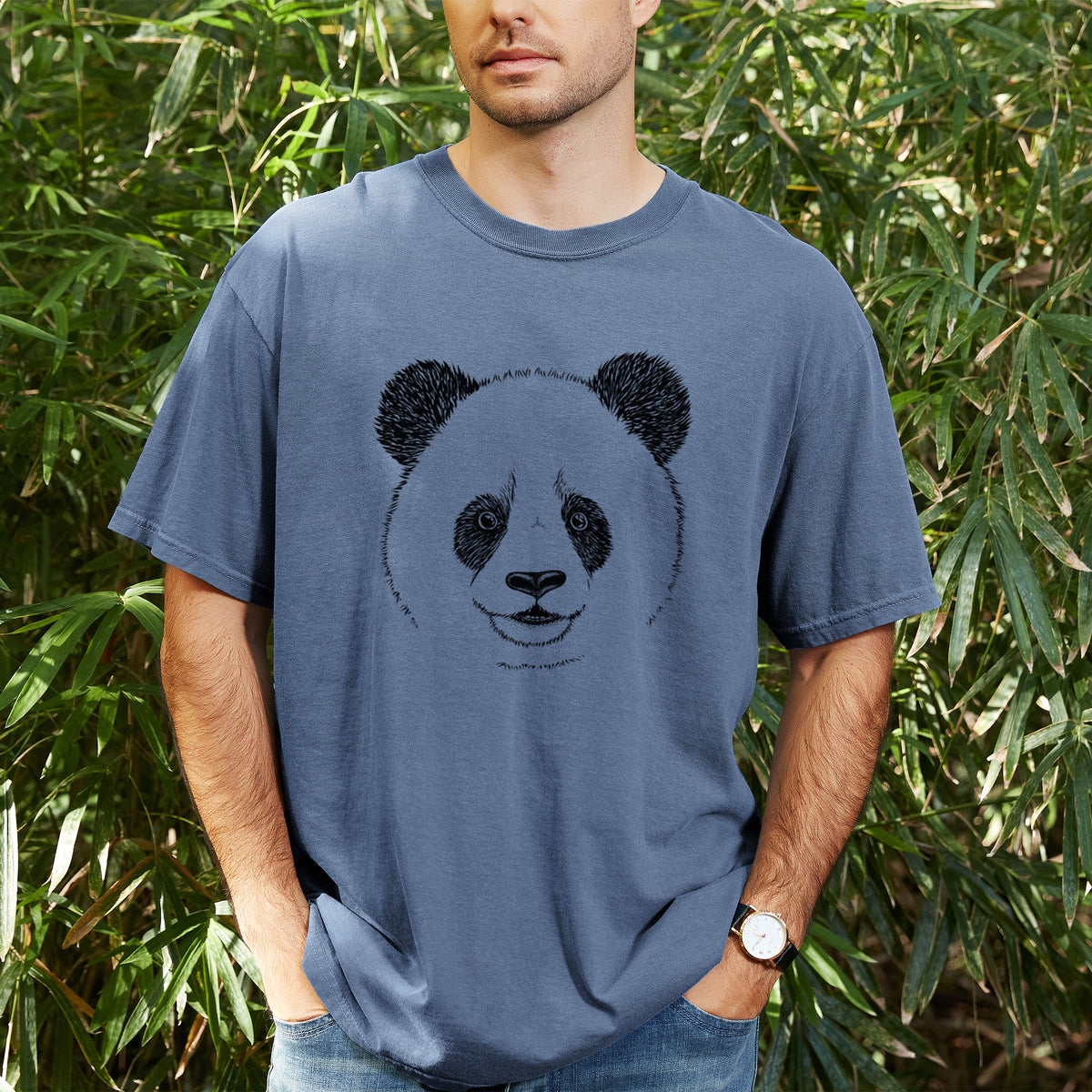 Man wearing a Comfort Colors t-shirt printed with a black ink portrait of a smiling giant panda's face, outdoors.