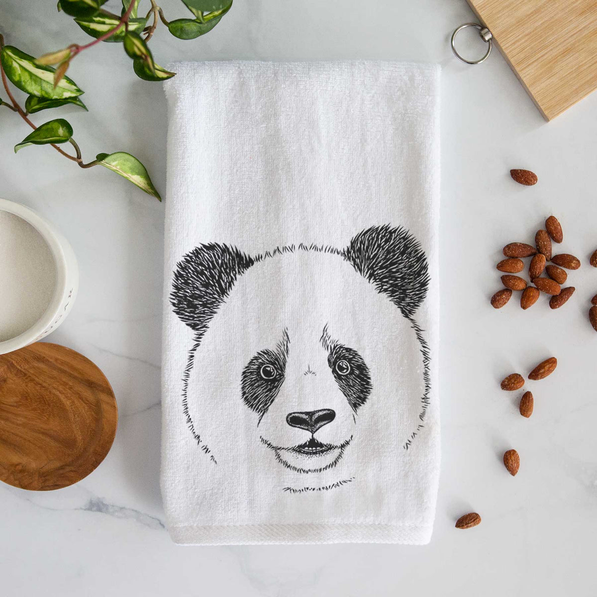 White hand towel printed with a black ink portrait of a smiling giant panda's face.