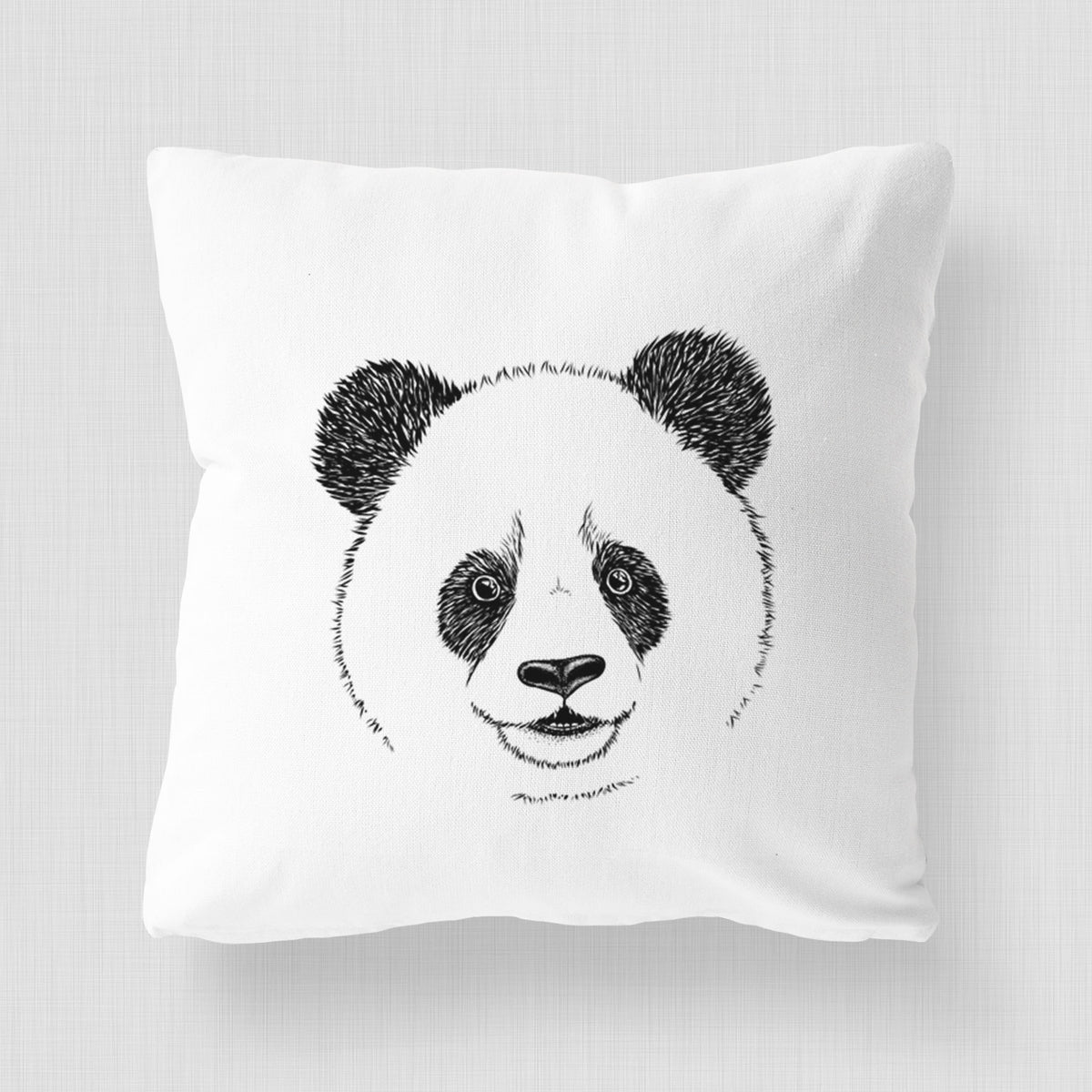 White pillow cover printed with a black ink portrait of a smiling giant panda's face.