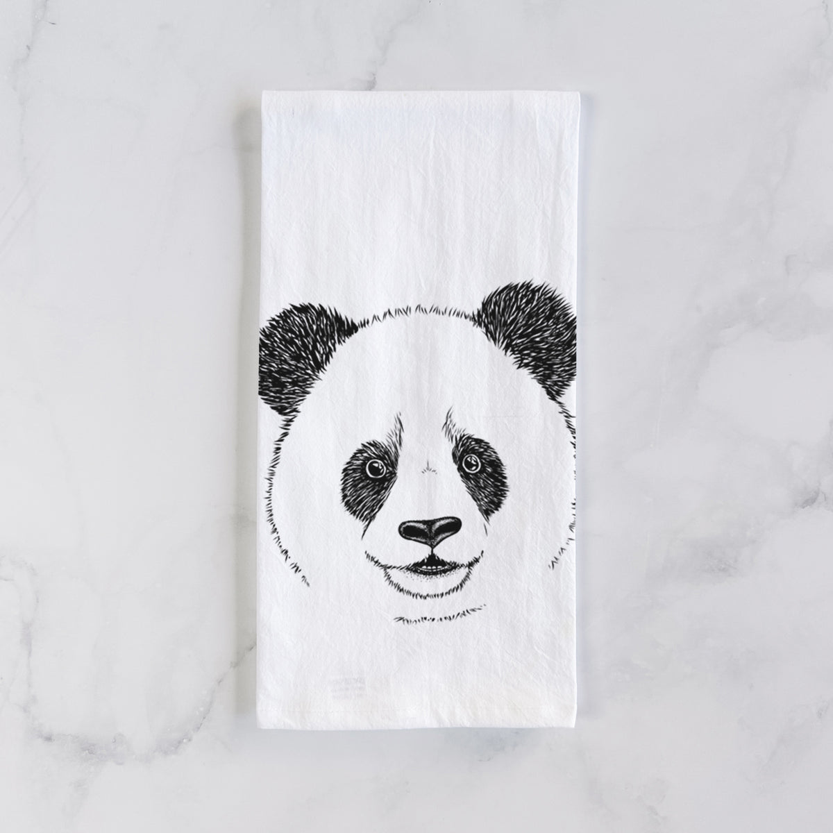 White cotton tea towel laid flat on marble, printed with a black ink portrait of a smiling giant panda's face.