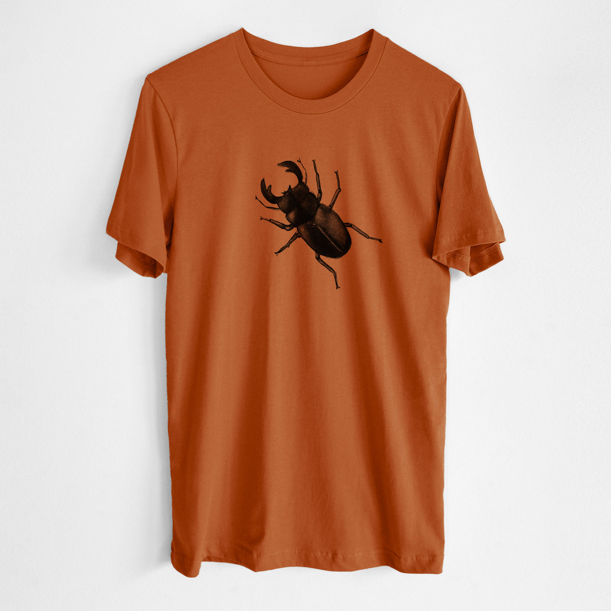 Autumn lightweight cotton t-shirt laid flat, printed with a detailed black ink illustration of a giant stag beetle with large jaws, seen from above.