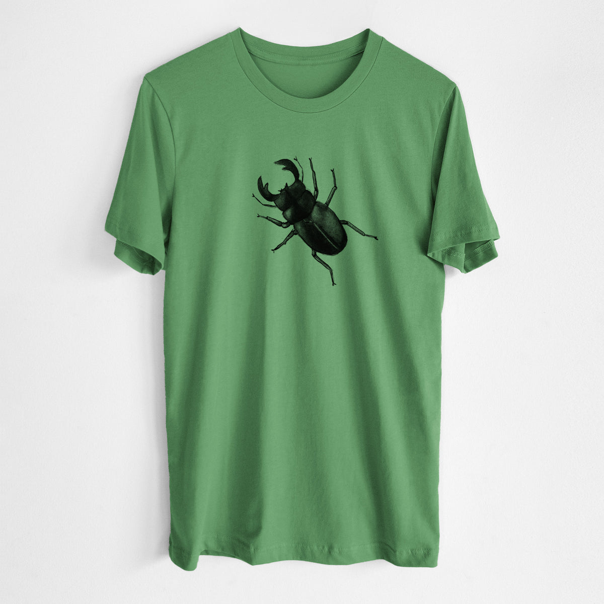 Leaf green lightweight cotton t-shirt laid flat, printed with a detailed black ink illustration of a giant stag beetle with large jaws, seen from above.