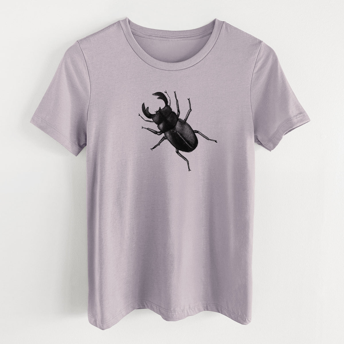 Light violet women's relaxed fit cotton t-shirt laid flat, printed with a detailed black ink illustration of a giant stag beetle with large jaws, seen from above.