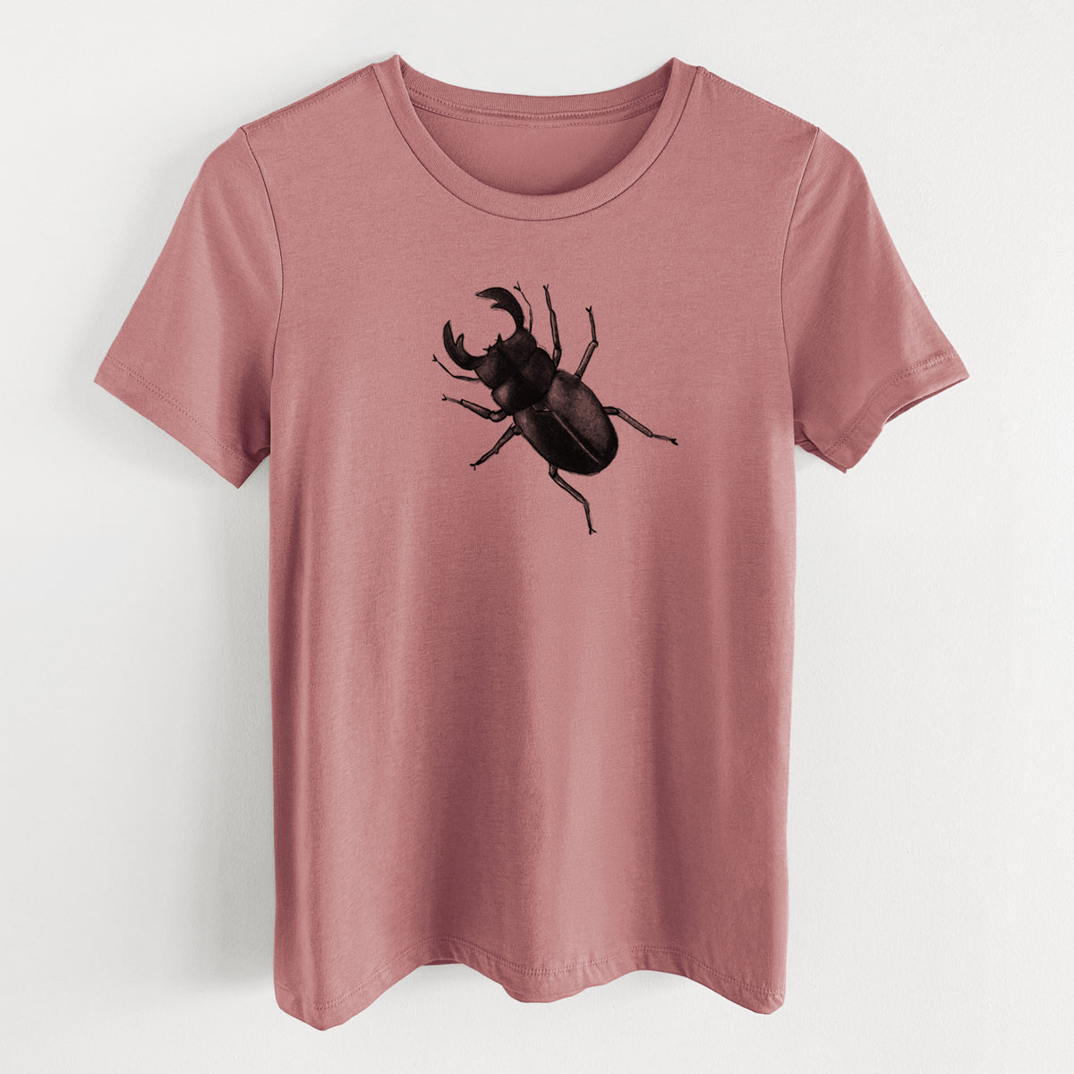 Mauve pink women's relaxed fit cotton t-shirt laid flat, printed with a detailed black ink illustration of a giant stag beetle with large jaws, seen from above.