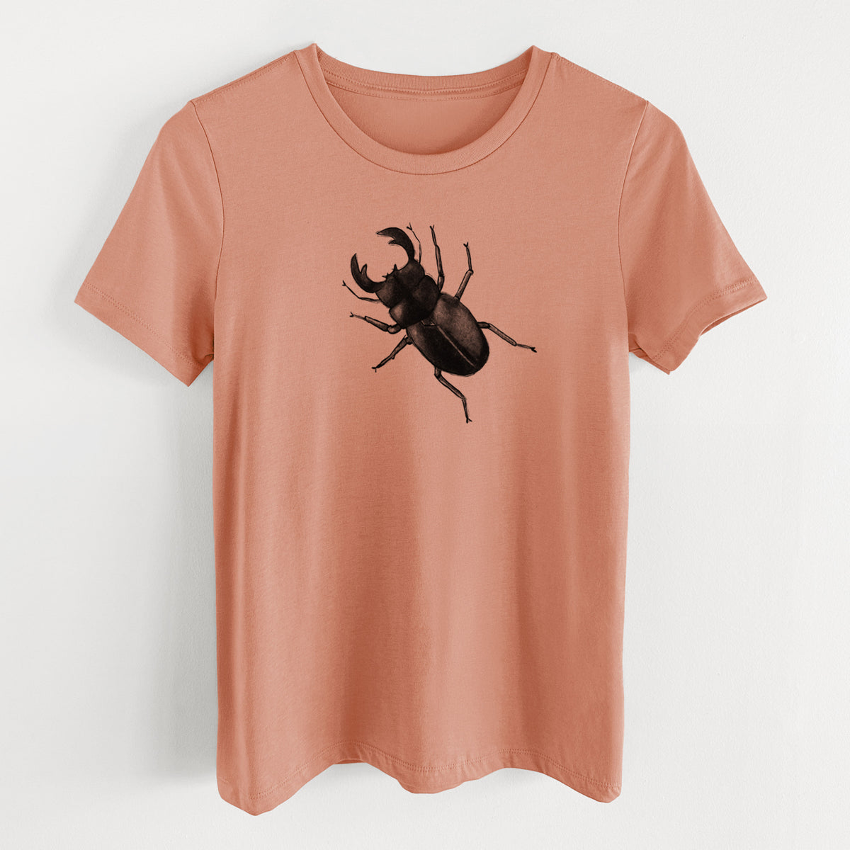 Terracotta orange women's relaxed fit cotton t-shirt laid flat, printed with a detailed black ink illustration of a giant stag beetle with large jaws, seen from above.