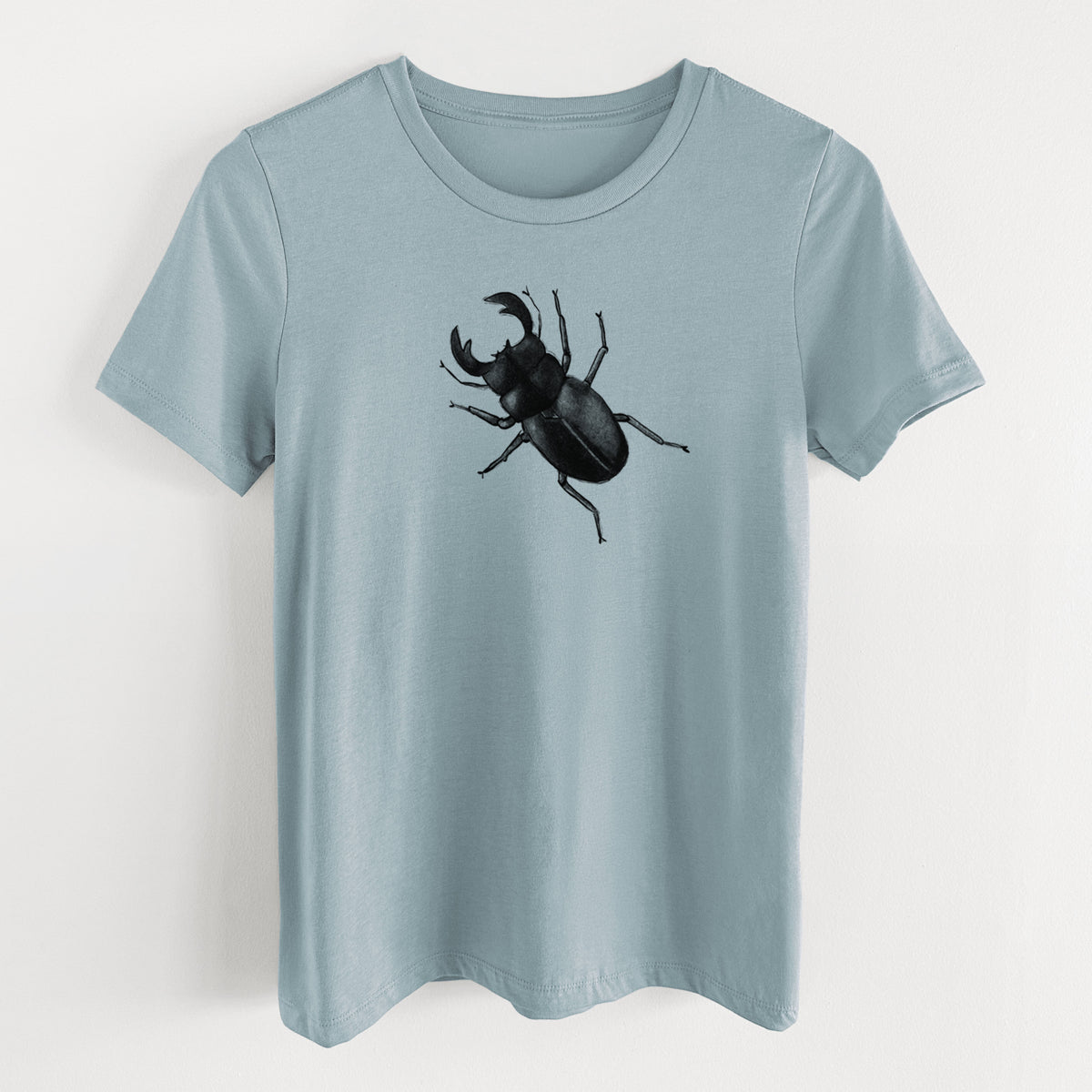 Vintage denim women's relaxed fit cotton t-shirt laid flat, printed with a detailed black ink illustration of a giant stag beetle with large jaws, seen from above.