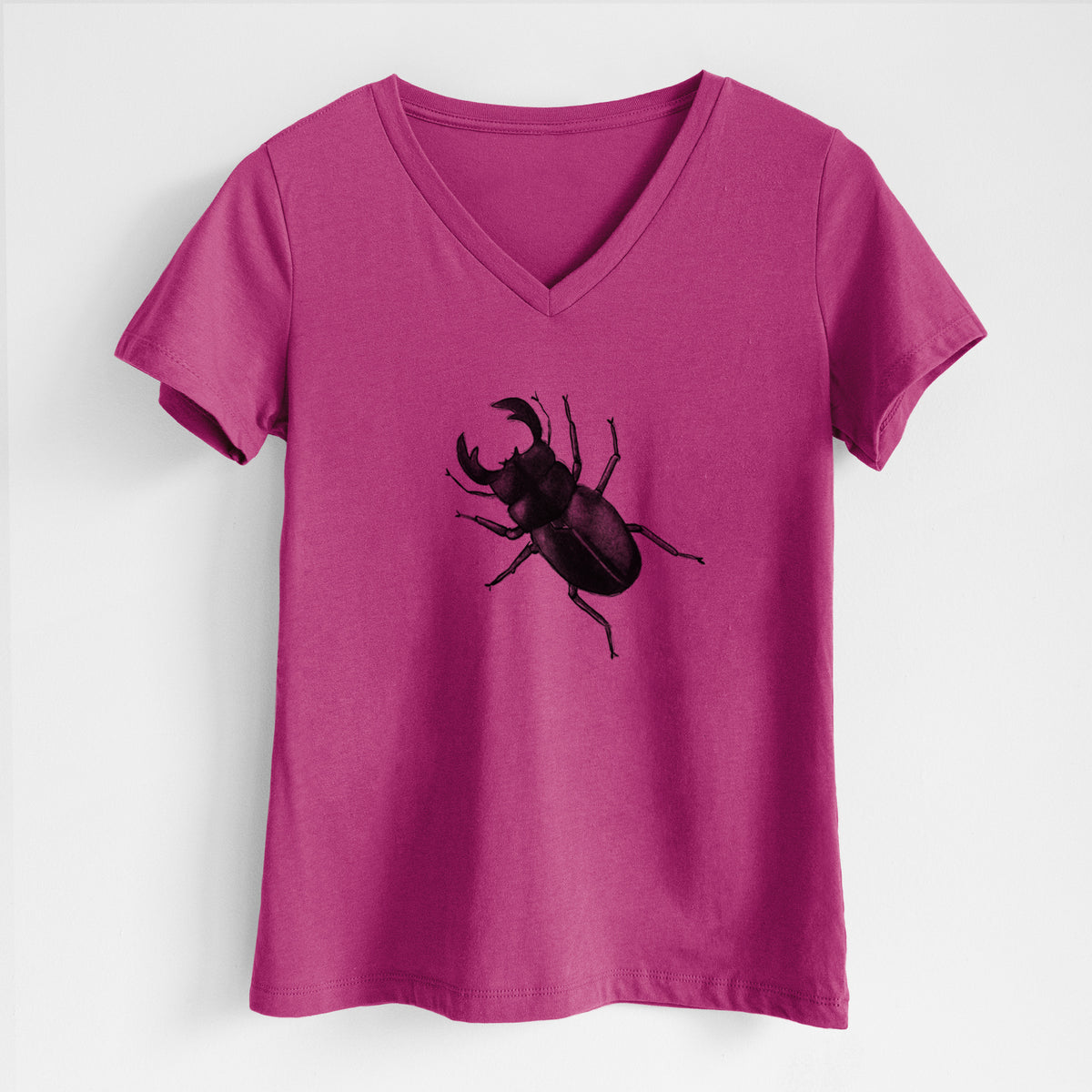 Berry pink women's relaxed fit cotton V-neck t-shirt laid flat, printed with a detailed black ink illustration of a giant stag beetle with large jaws, seen from above.